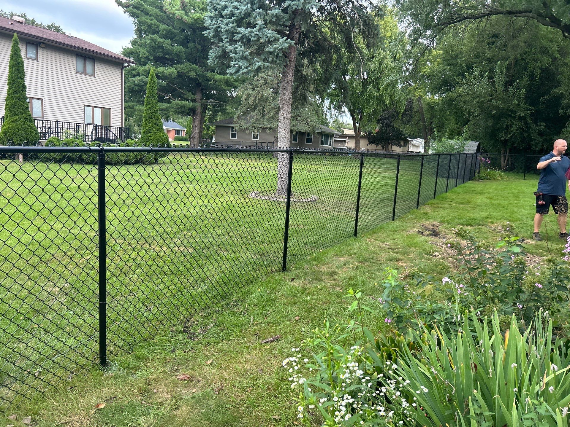 Black Vinyl Coated Chain Link Fence Installation in Waterloo by Perfect Picket Fence and Stain