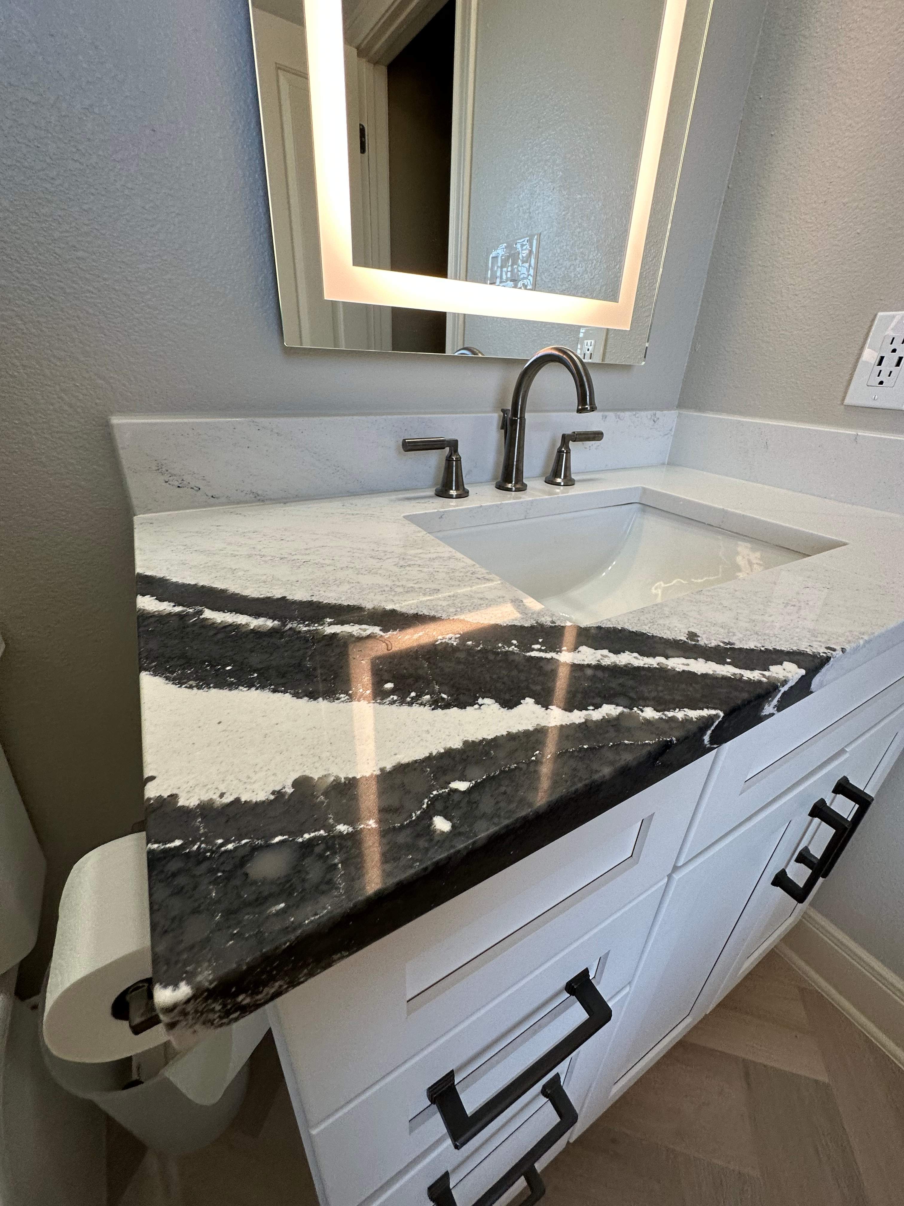 Boerne Guest Bathroom Remodel with Marble Tub Surround & Herringbone Flooring by Legacy Bath and Kitchen