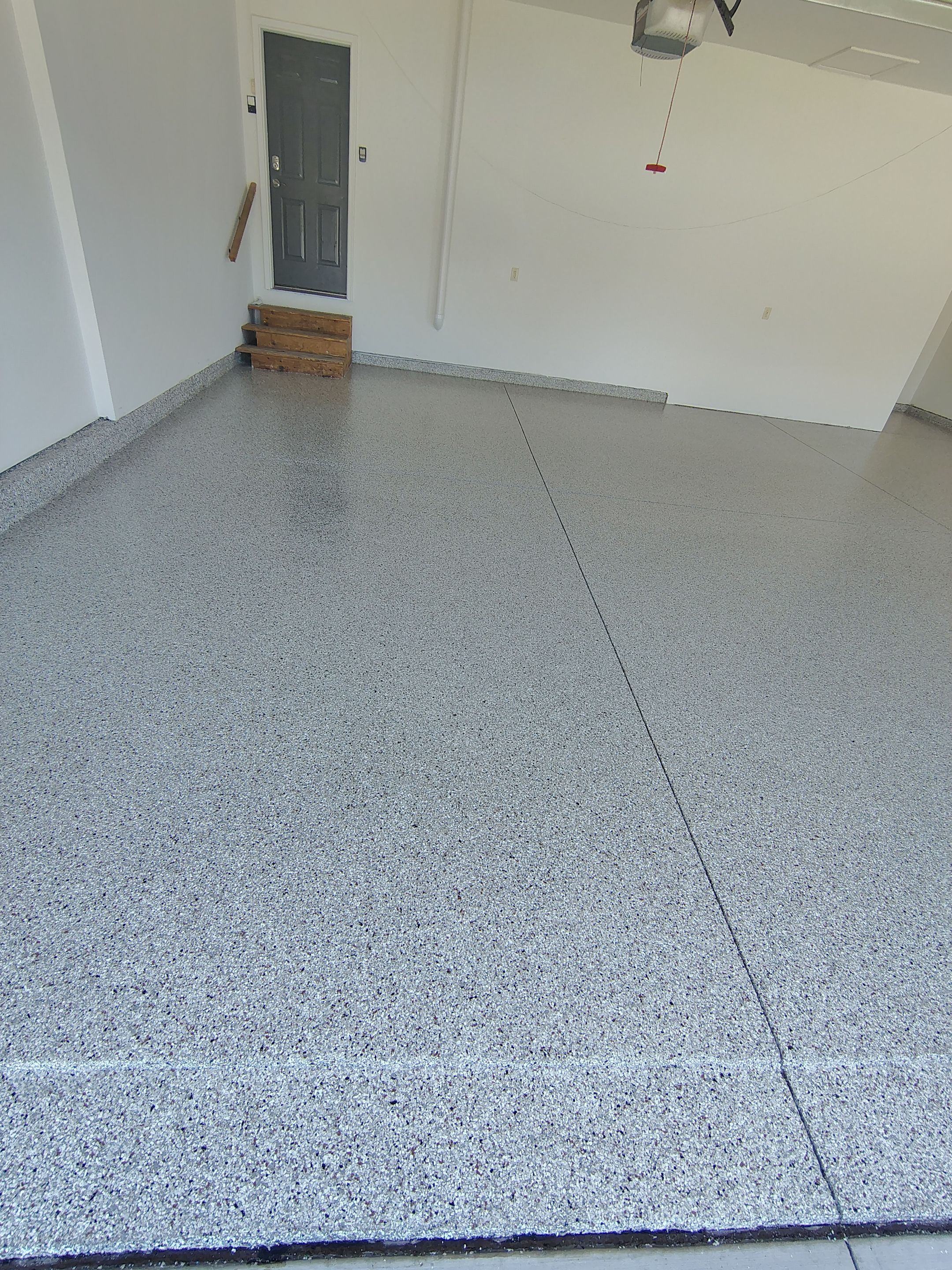 Custom Grey Speckled Epoxy Floor Coating for Sioux Falls Garage by Select Painting, Coatings & Garage Cabinets