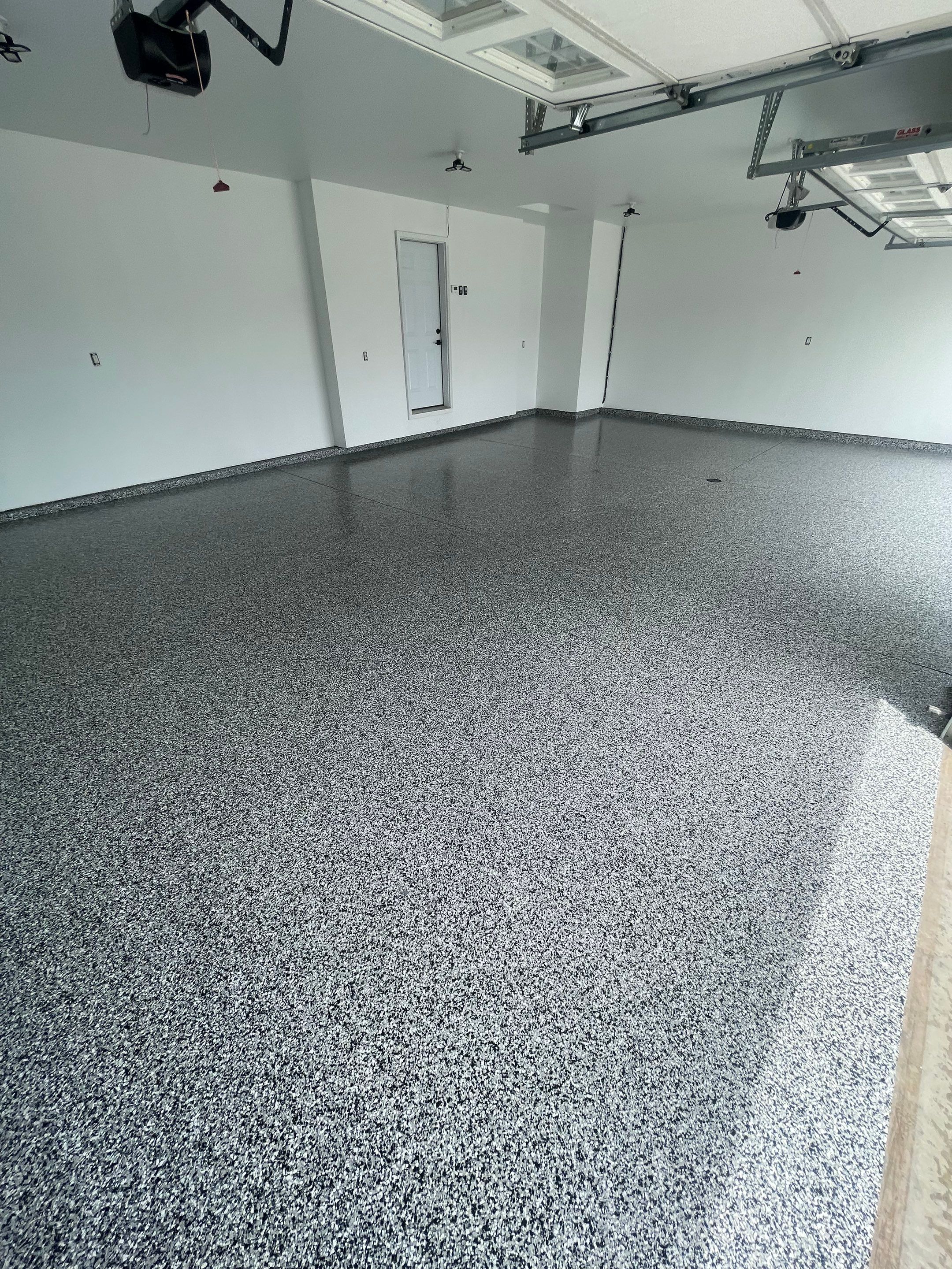 Grey Flake Epoxy Garage Floor Coating in Sioux Falls by Select Painting, Coatings & Garage Cabinets