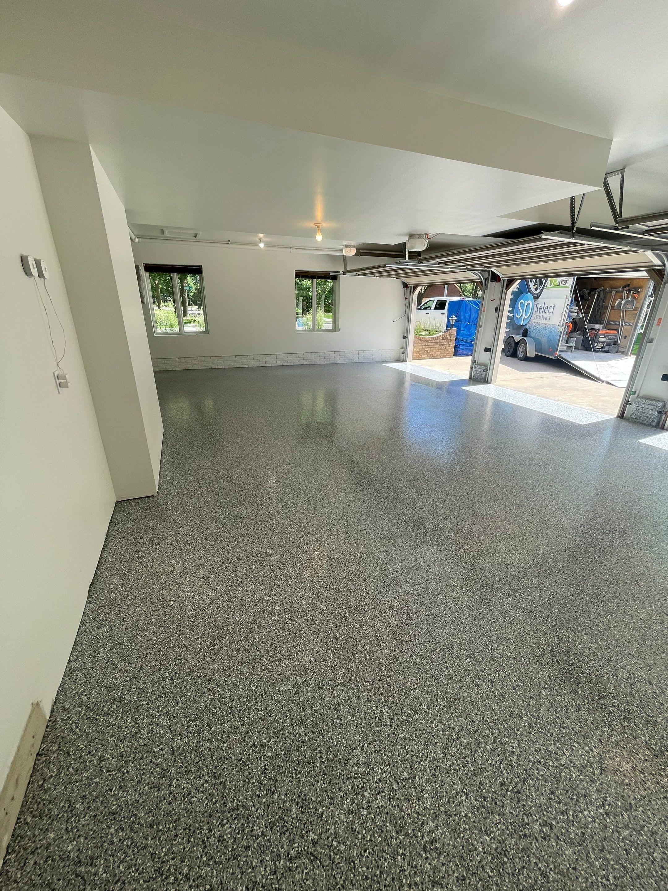 Gray Speckled Epoxy Garage Floor Coating in Sioux Falls by Select Painting, Coatings & Garage Cabinets