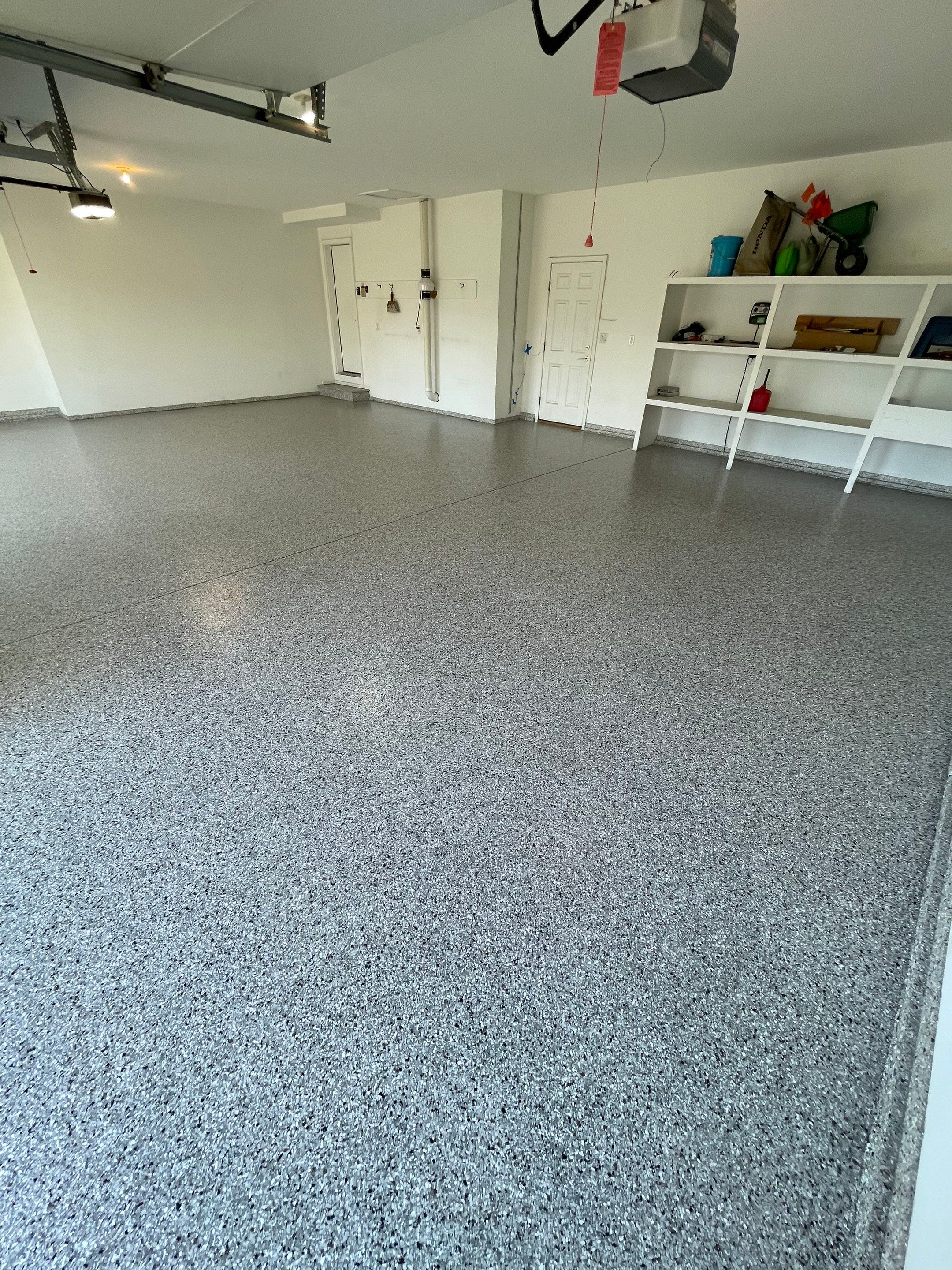 Yankton Garage Floor Restoration with Gray Speckled Epoxy Coating by Select Painting, Coatings & Garage Cabinets