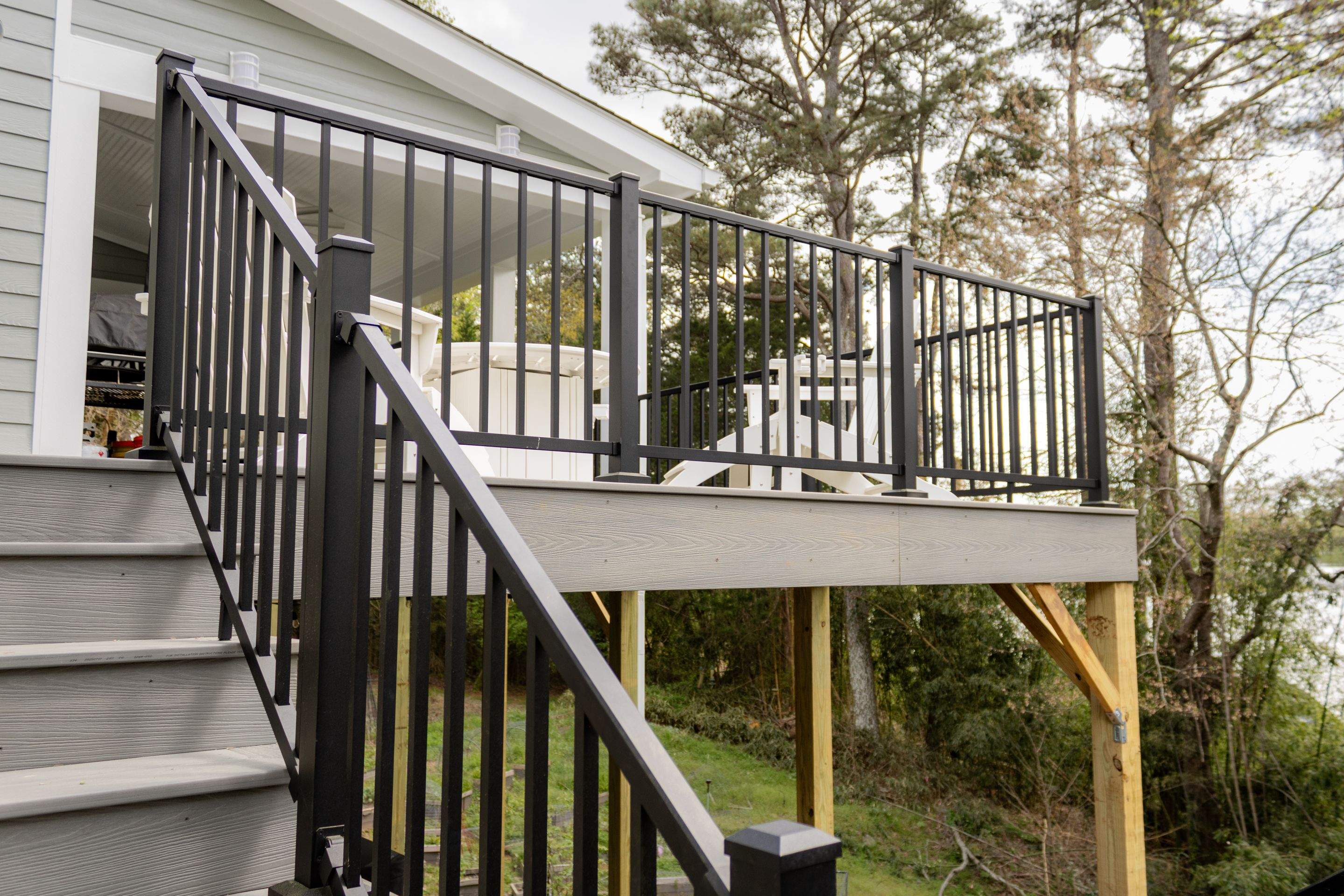 Covered Porch and Deck Build using Deckorators Venture Series Decking and Trex Select Aluminum Railing by Nelson Exteriors