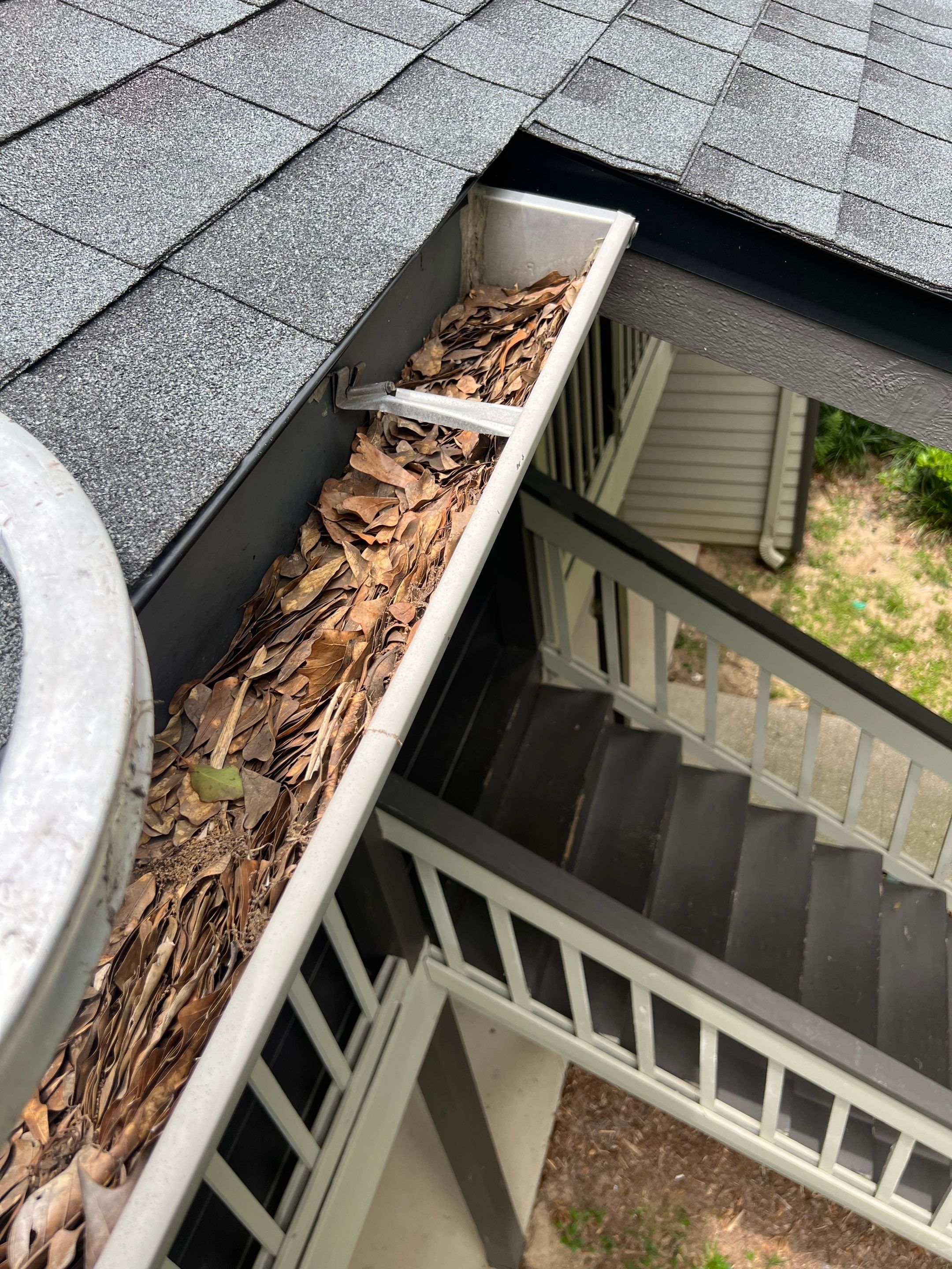 Commercial gutter cleaning Dothan, AL before photo with filled gutters