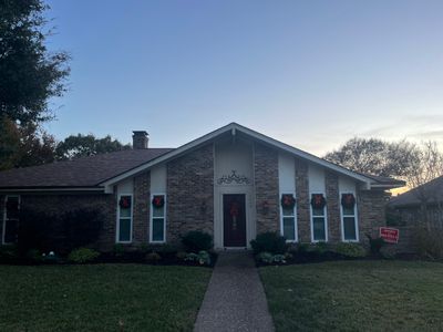 Brick with white area around windows with Malarkey Sienna Blend