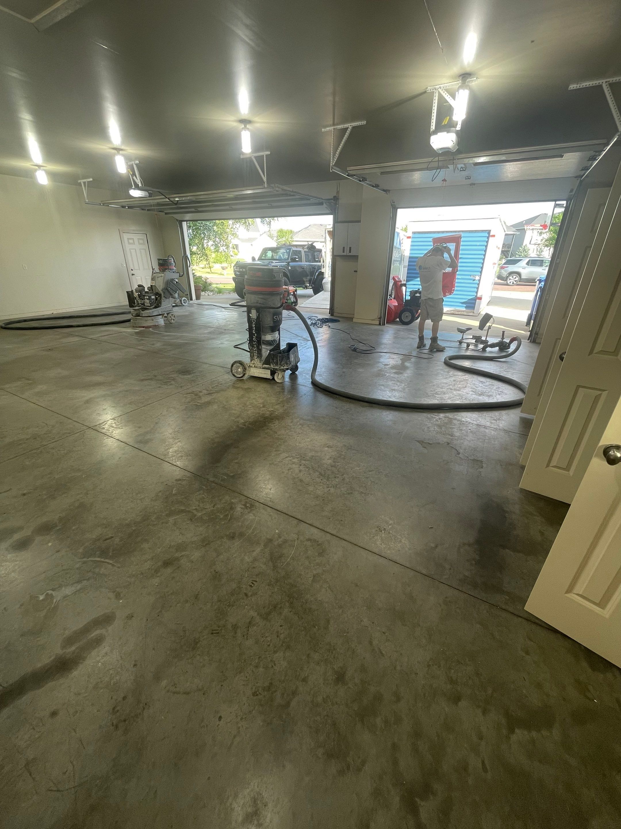 Coyote Flake Garage Floor Coating in Sioux Falls with Trench Drain by Select Painting, Coatings & Garage Cabinets