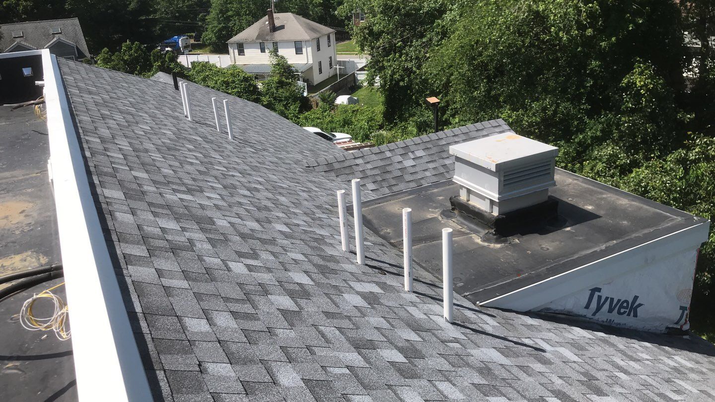 Commercial Roofing Installation using EPDM with white gutters by A Plus Exterior