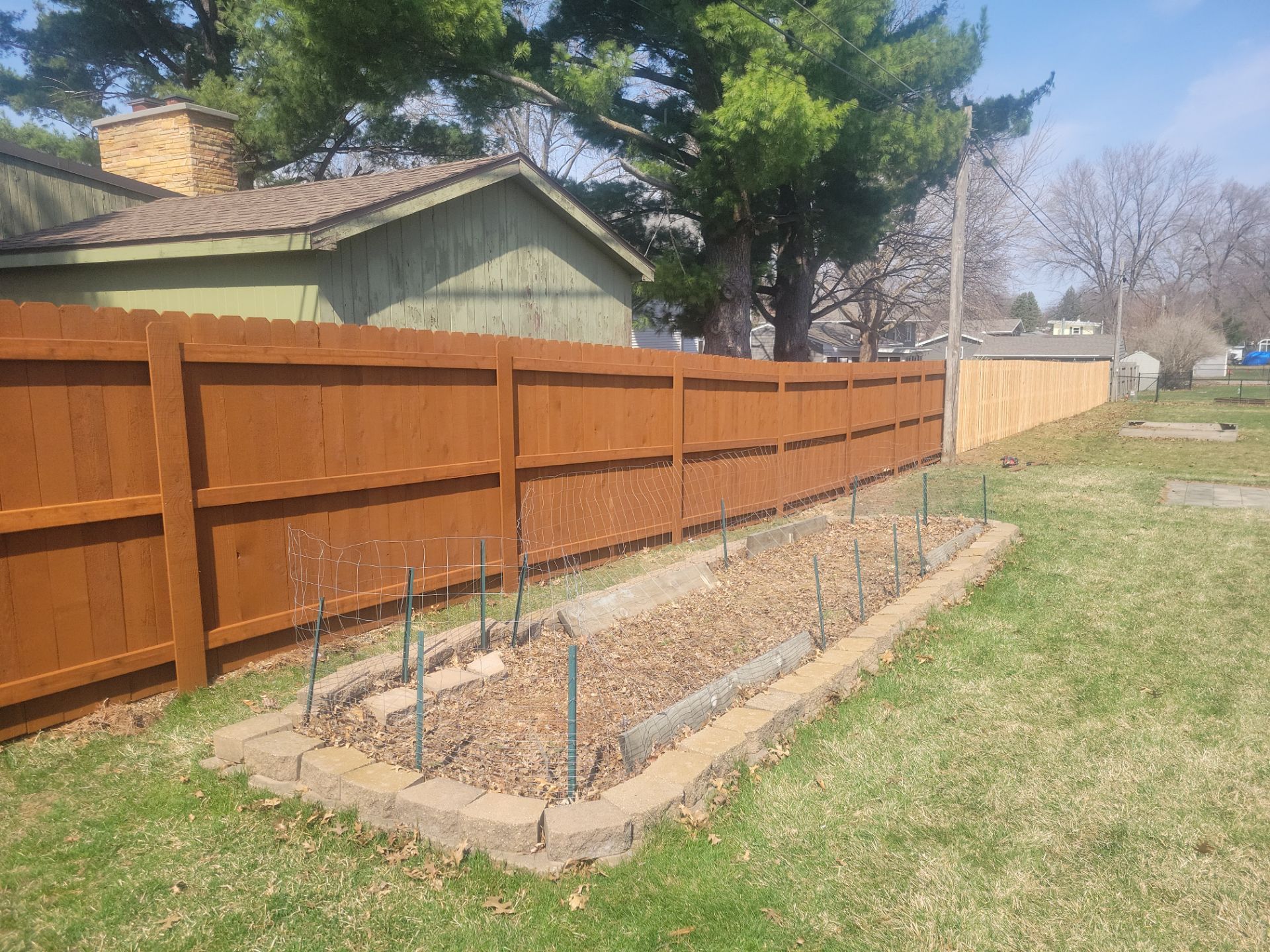 Stained Cedar Wood Privacy Fence Installation in Cedar Falls by Perfect Picket Fence and Stain