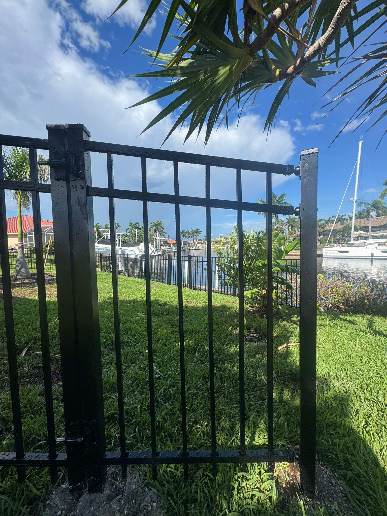 Black Aluminum Fence Installation Along Punta Gorda Canal by True Fence LLC