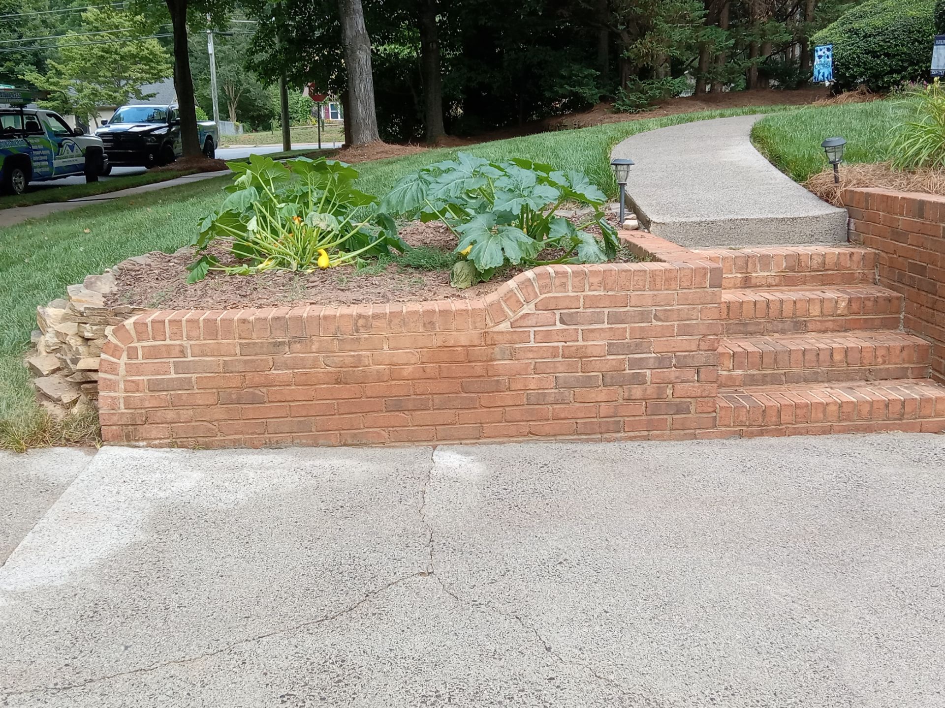 pressure washing brick steps and concrete walkway removing dirt buildup for cleaner appearance