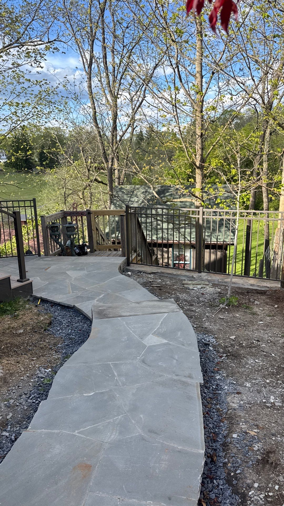 Custom Composite Deck with Stone Fireplace and Modern Cable Railing by Walnut Hollow Decks & Outdoor Living