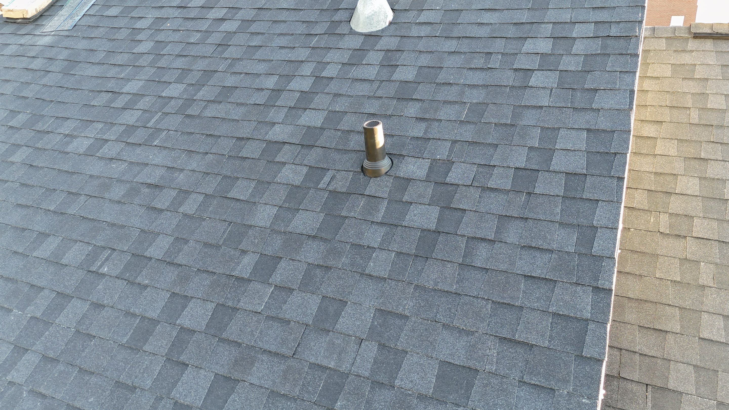 Charcoal Black Re-Roof & Gutters by Royal House LLC