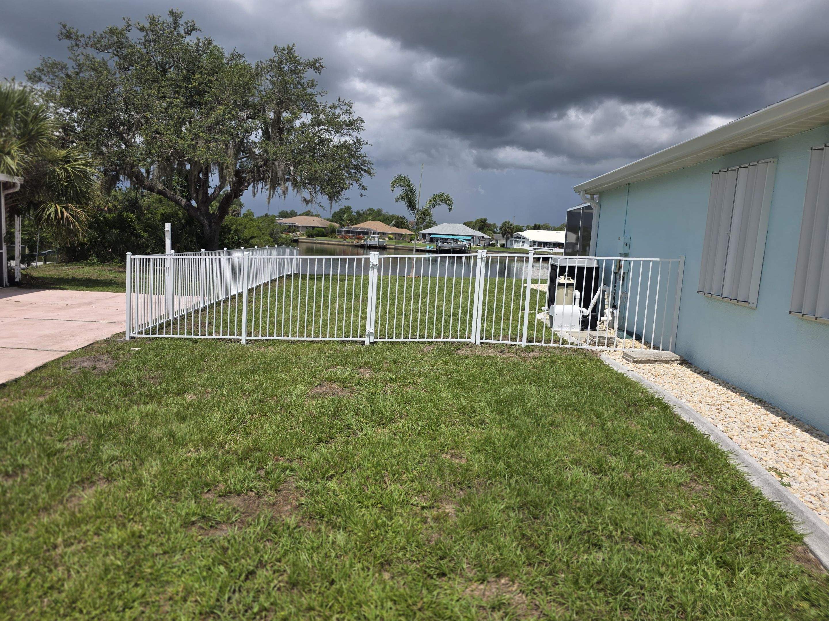 White Aluminum Picket Fence Installation for Port Charlotte Waterfront Home by True Fence LLC