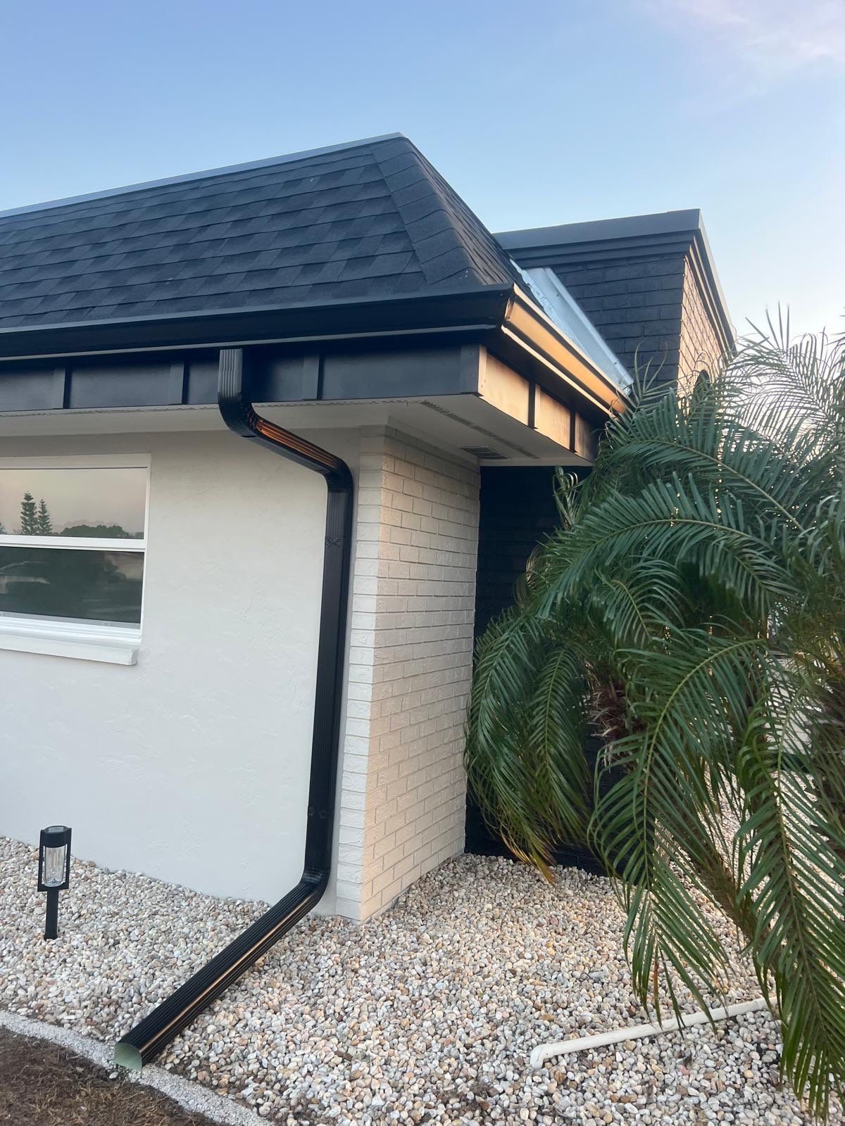 Black 6'' Seamless Gutters K-Style and Black Downspouts in Sun City Center FL by Gutter Professors