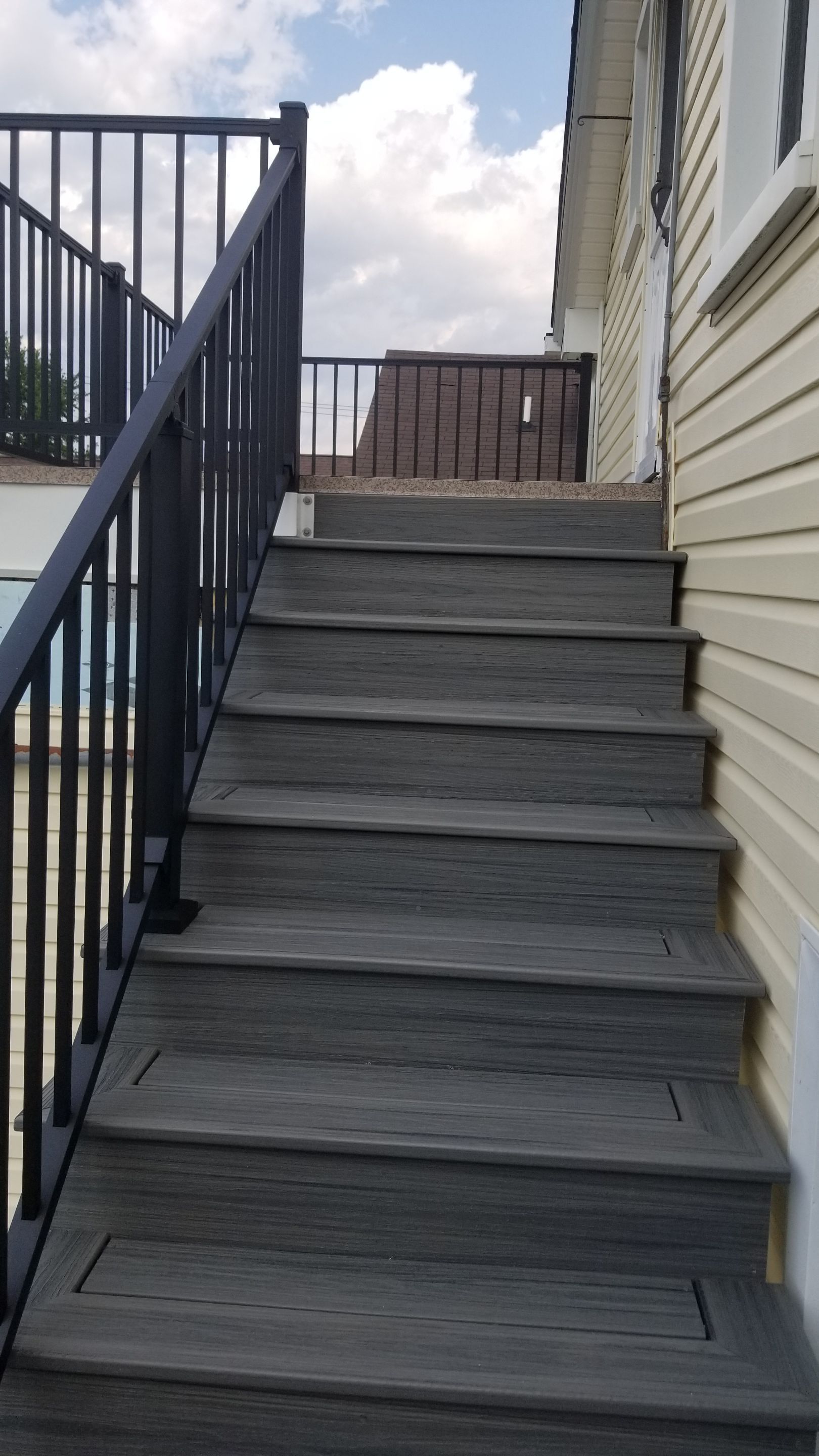 Rebuild balcony flat roofing TREX decking stairway and Railings in Wyandotte, MI by Northwest Construction 
