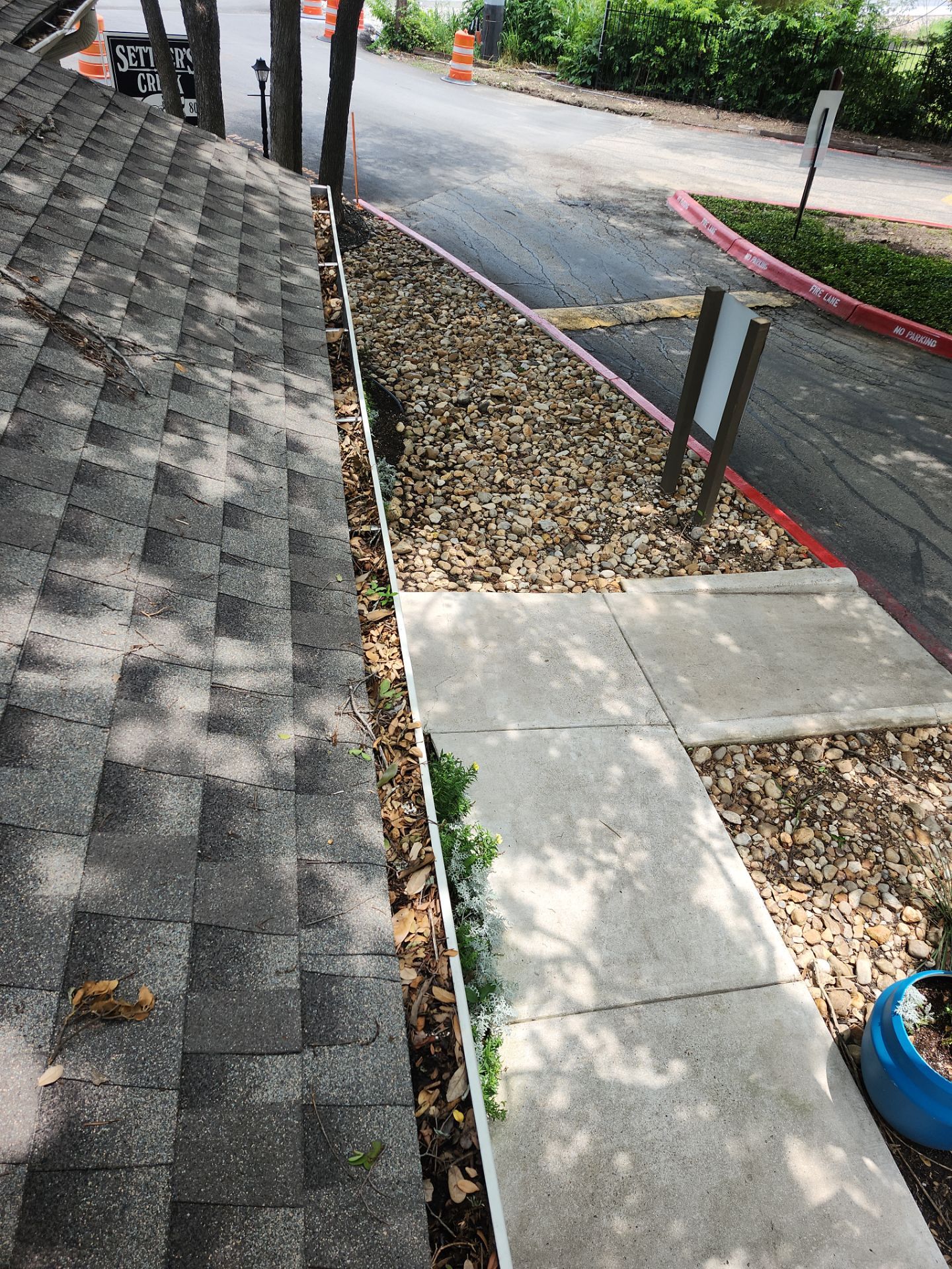Commercial gutter cleaning San Marcos & New Braunfels, TX before photo with filled gutters