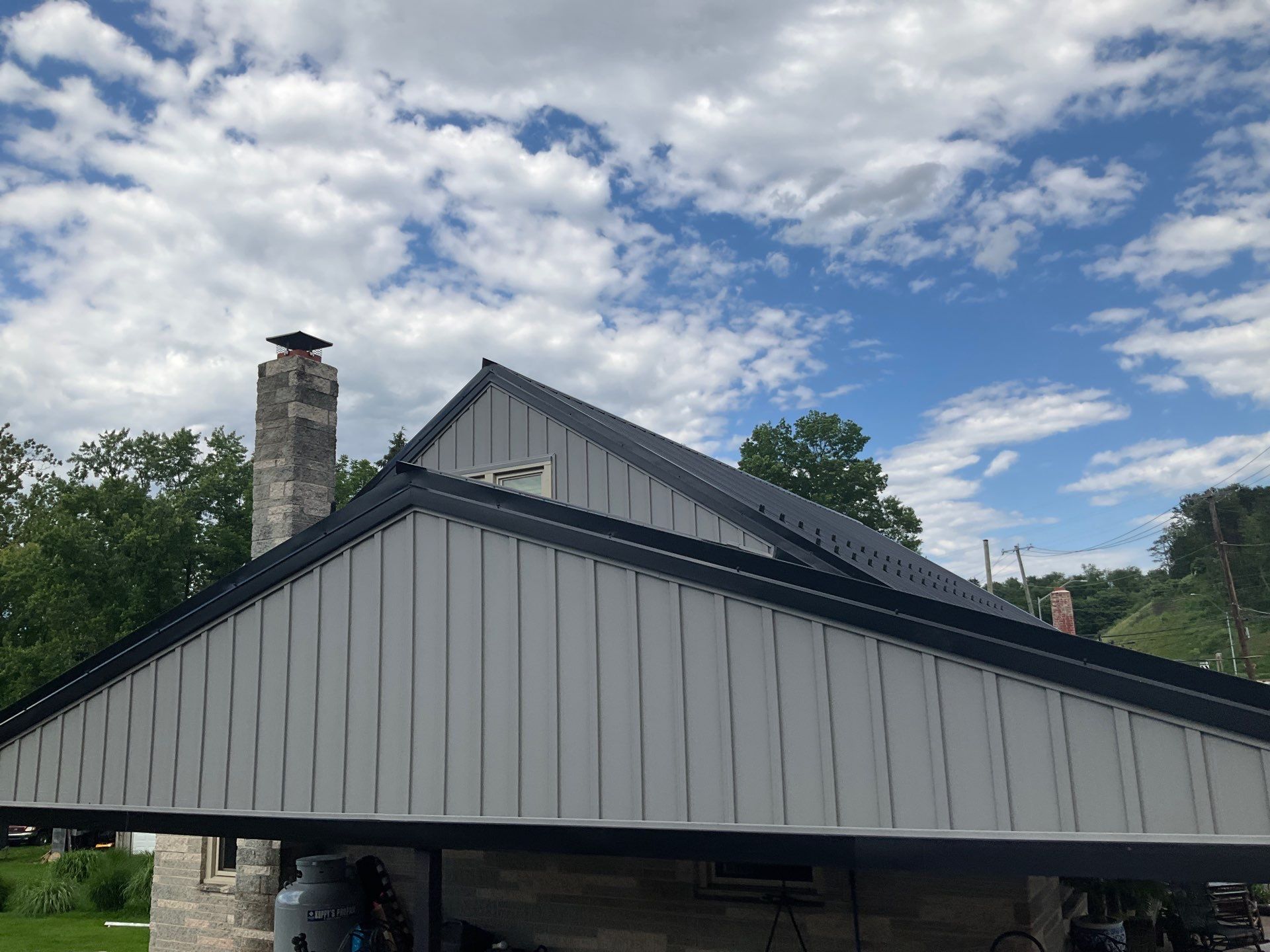 Metal Roofing, Board & Batten Siding, and Entry Door Transformation by Esh Builders
