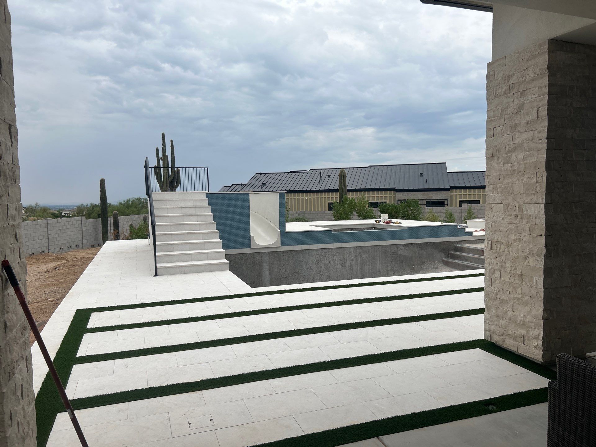 Pool and spa build with slide & outdoor kitchen by Modern Pools