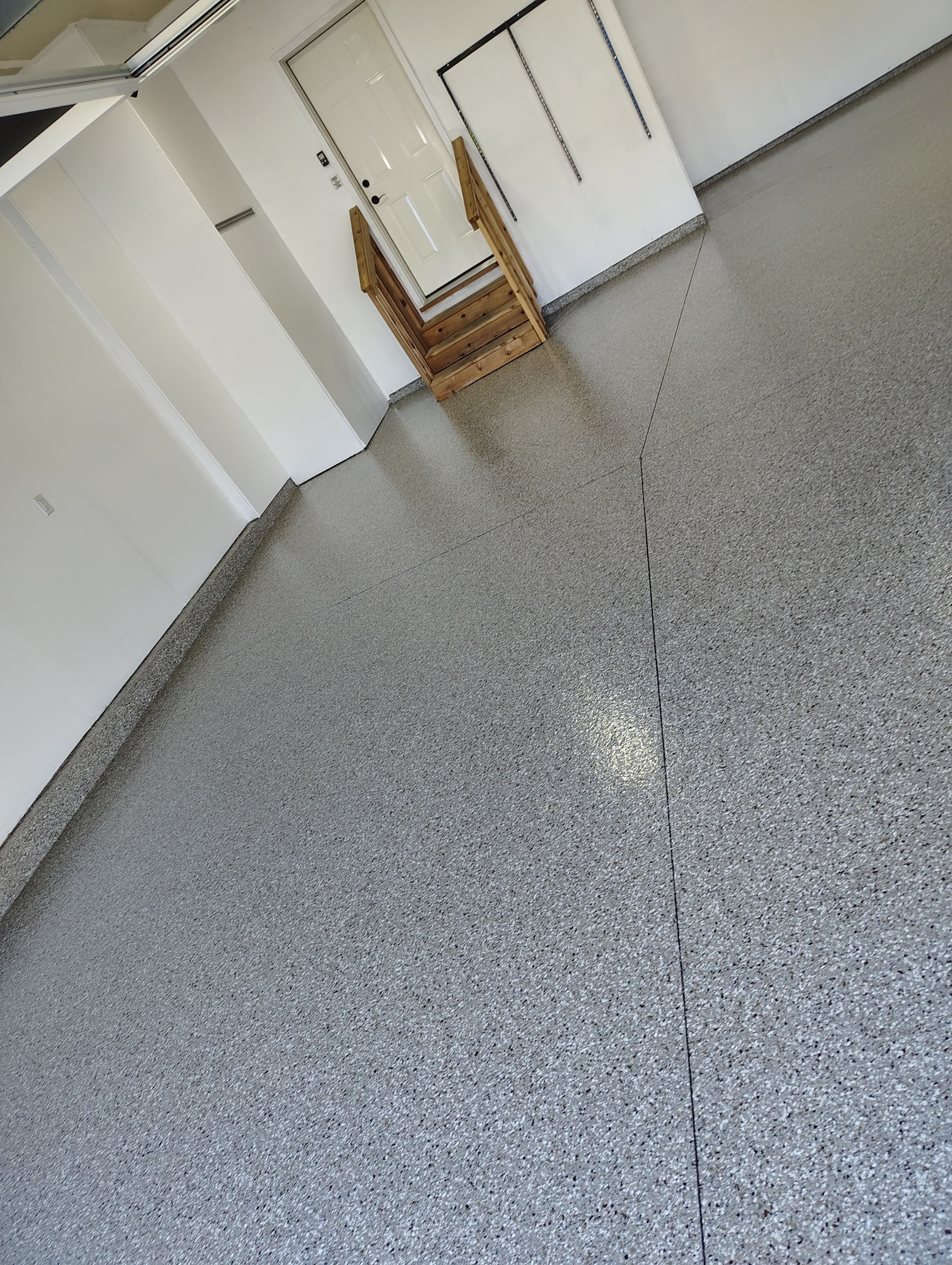 Sioux Falls Garage Floor Transformation With Gray Speckled Epoxy Coating by Select Painting, Coatings & Garage Cabinets