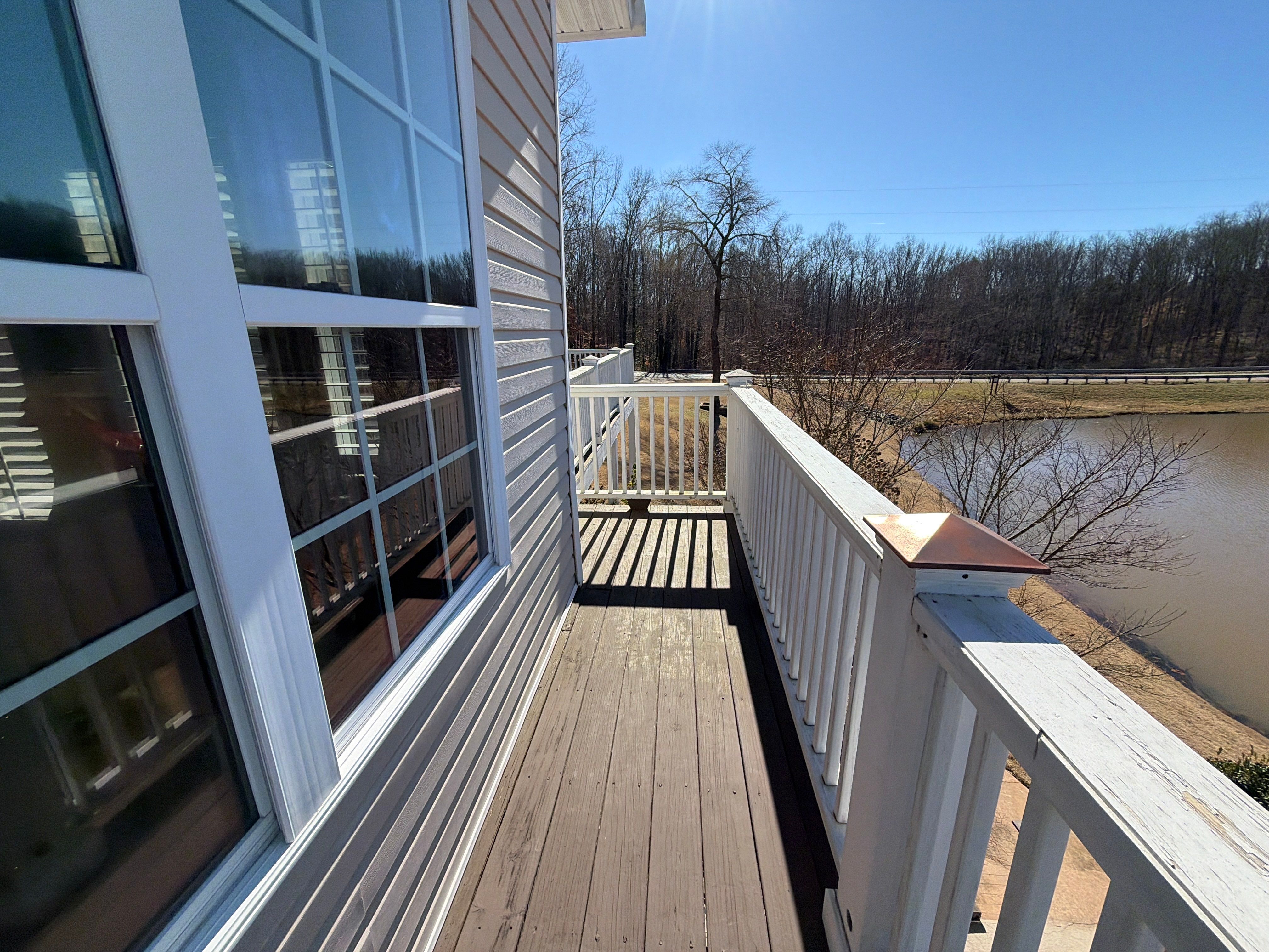 Cumming, GA Lake House Deck Resurface and Extension using Pressure Treated Pine and Skyline Cable Railing by Nelson Exteriors 