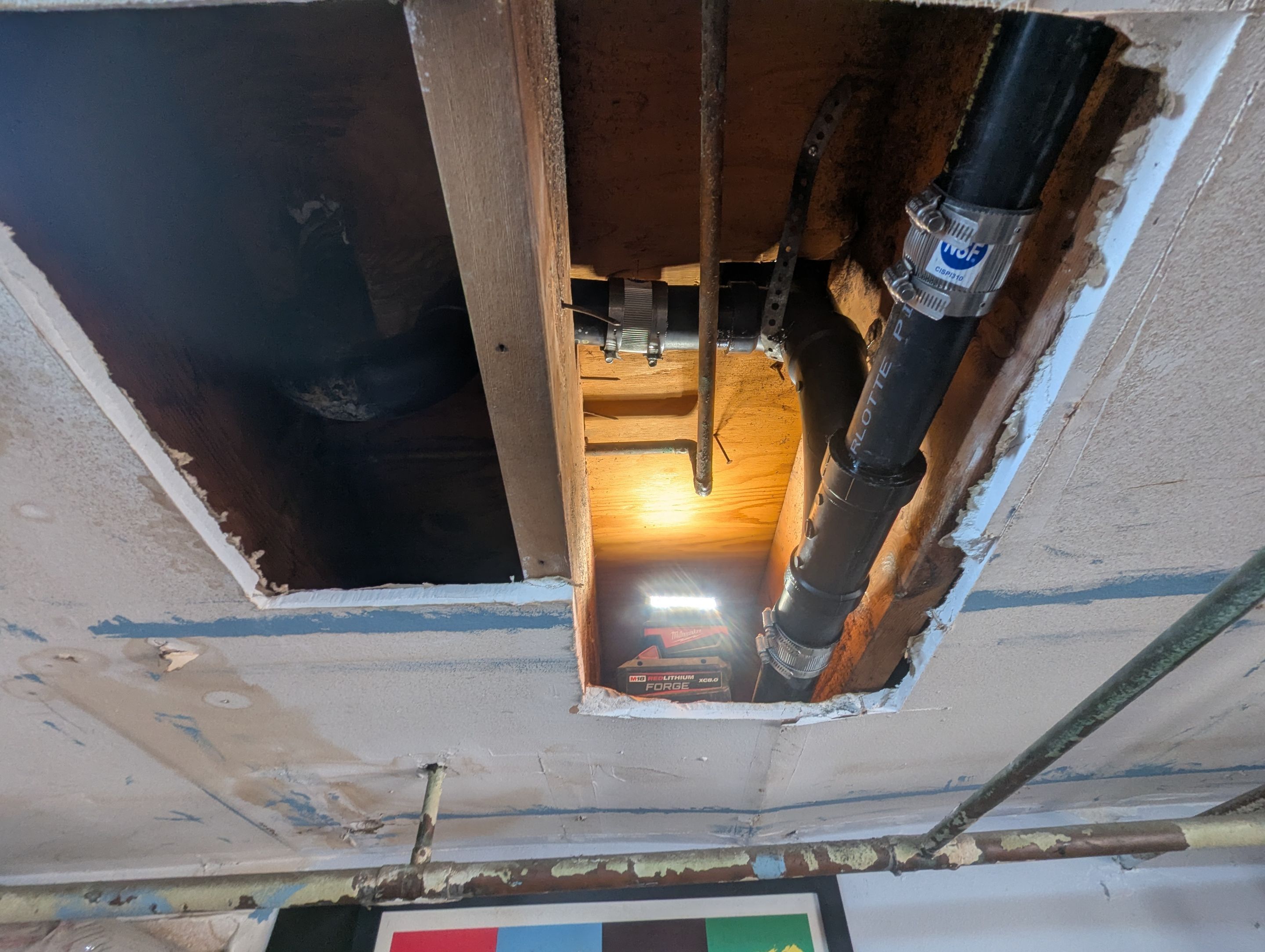Drain line leak in garage ceiling by Professional Plumbing Inc 