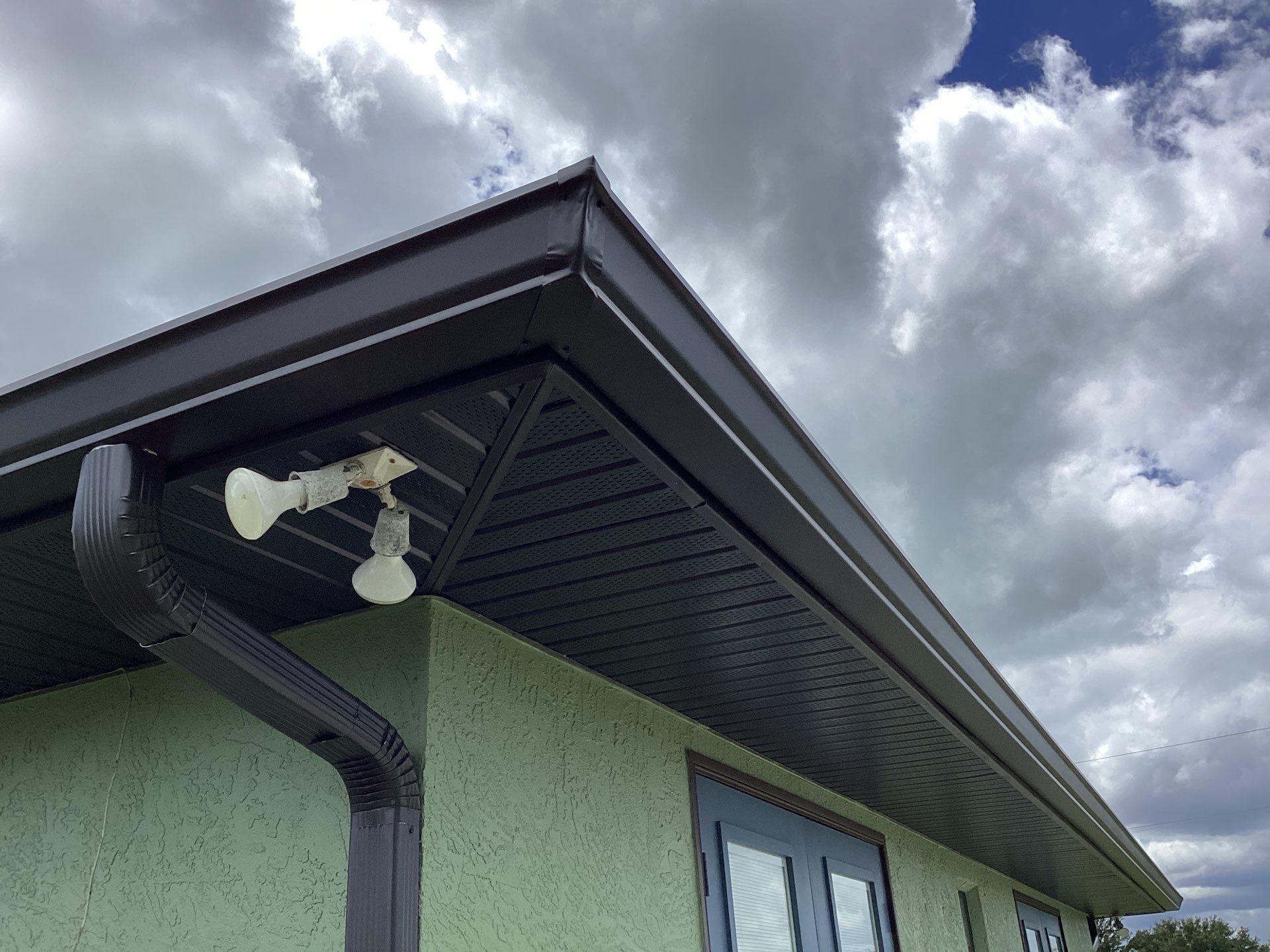 Musket brown downspouts with 6-inch K-Style gutter installation in Myakka City, FL by Gutter Professors