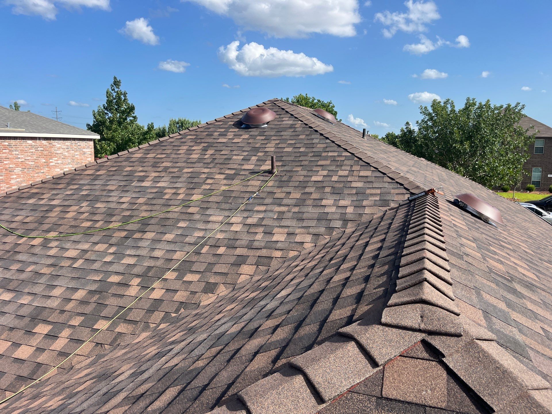 IKO Shadow Brown-Medium brown brick house by Tejas Roofworks + Restoration