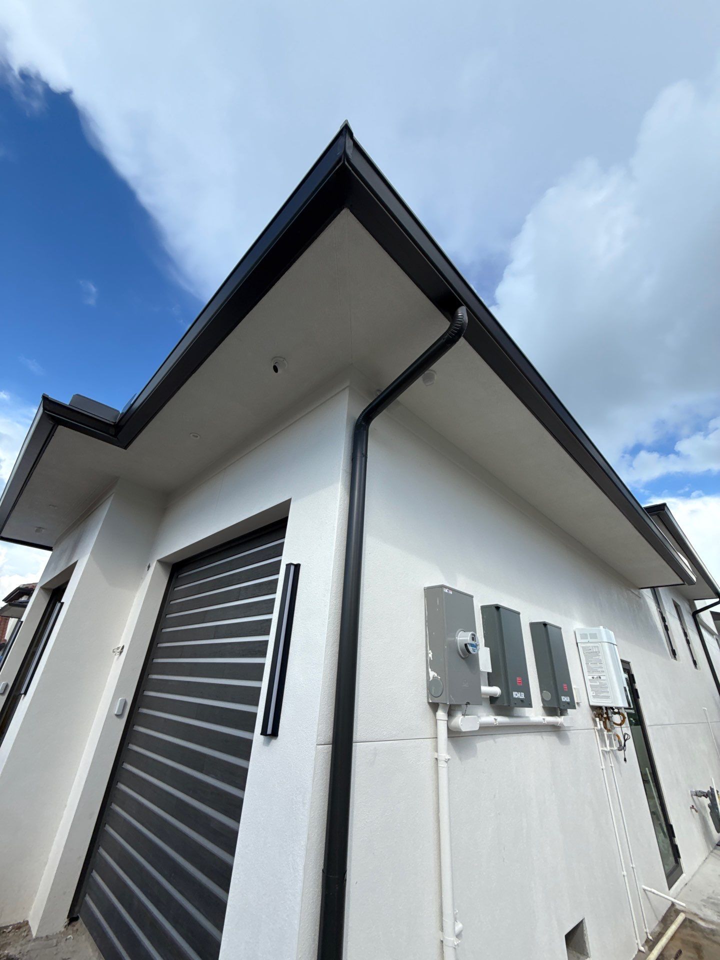 Seamless Aluminum Gutter Installation using black seamless gutters in Sarasota FL by Gutter Professors