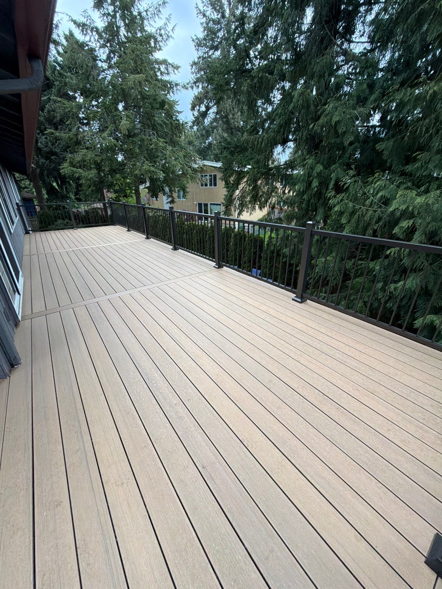 Elevated TimberTech Composite Deck Replacement With Black Metal Railings by Emerald City Energy