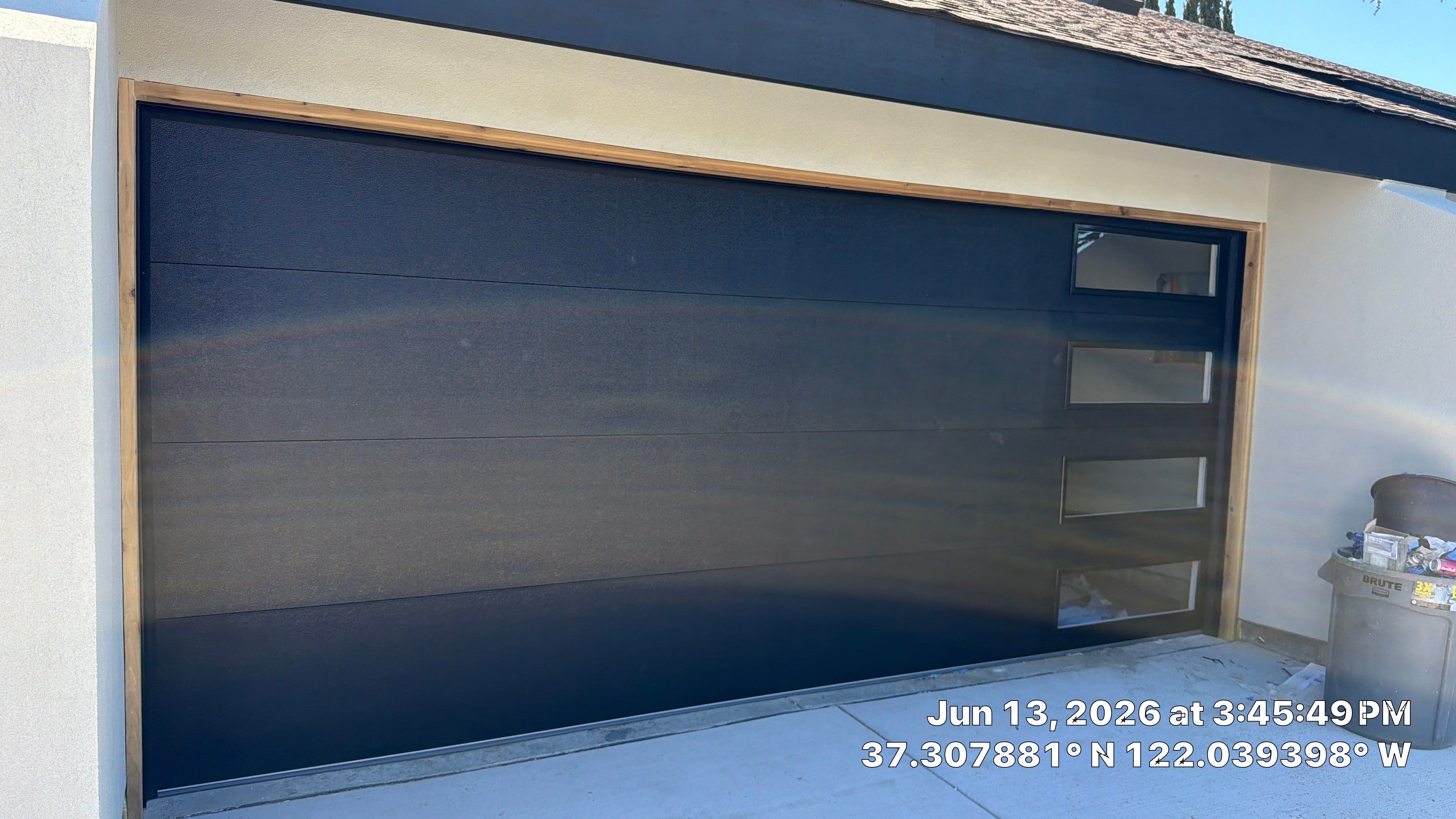 Modern Black Garage Door Installation With Vertical Windows In Cupertino by Valiant Garage Door