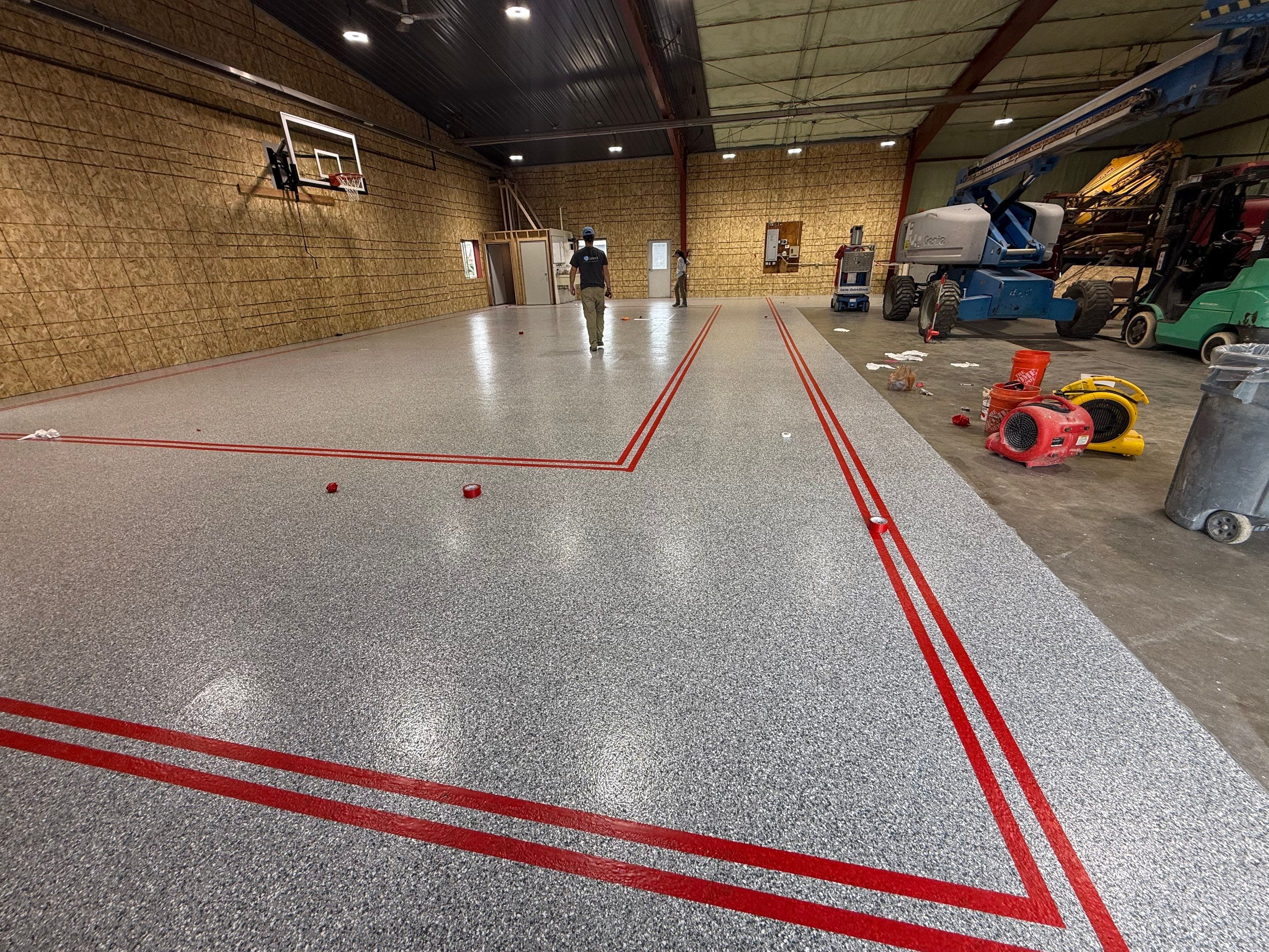 Custom Polyurea Shop Floor with Basketball Court Lines in Rock Valley by Select Painting, Coatings & Garage Cabinets