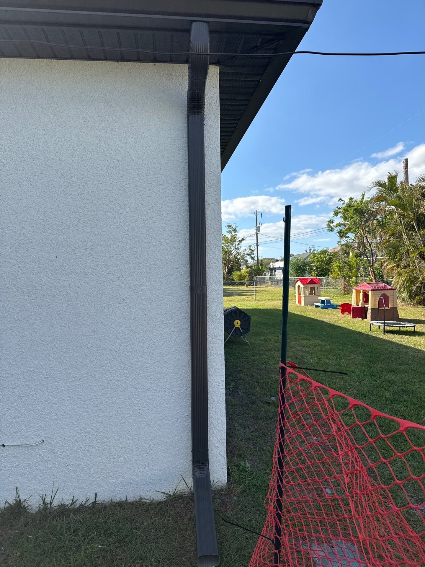 Dark Seamless Gutters and Downspouts in Cape Coral FL by Gutter Professors