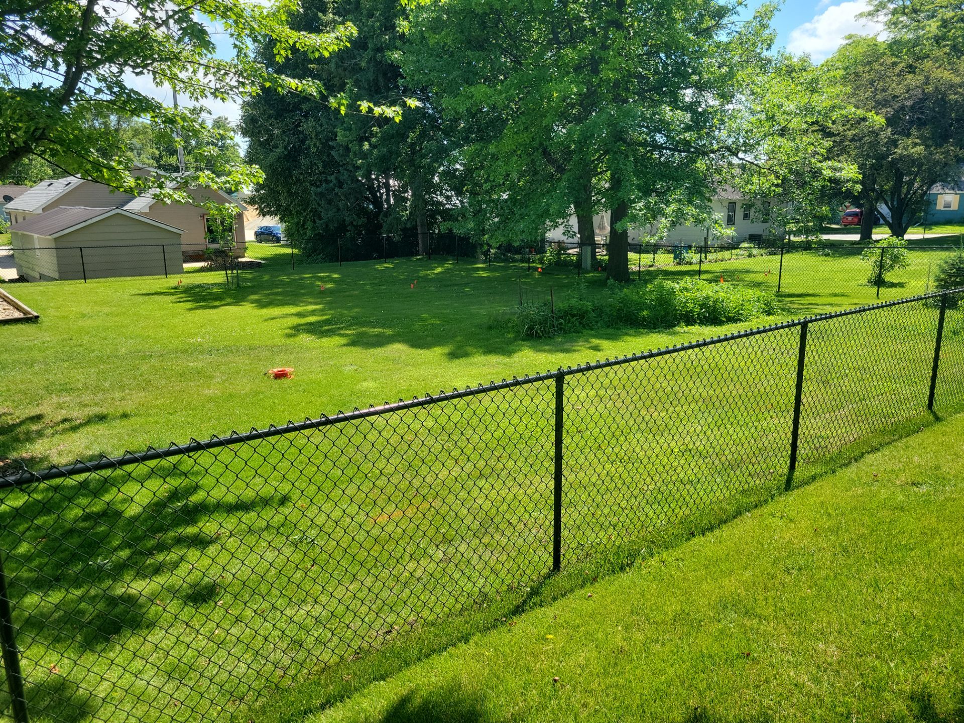 Black Chain Link Perimeter Fence and Driveway Gate in Waverly by Perfect Picket Fence and Stain
