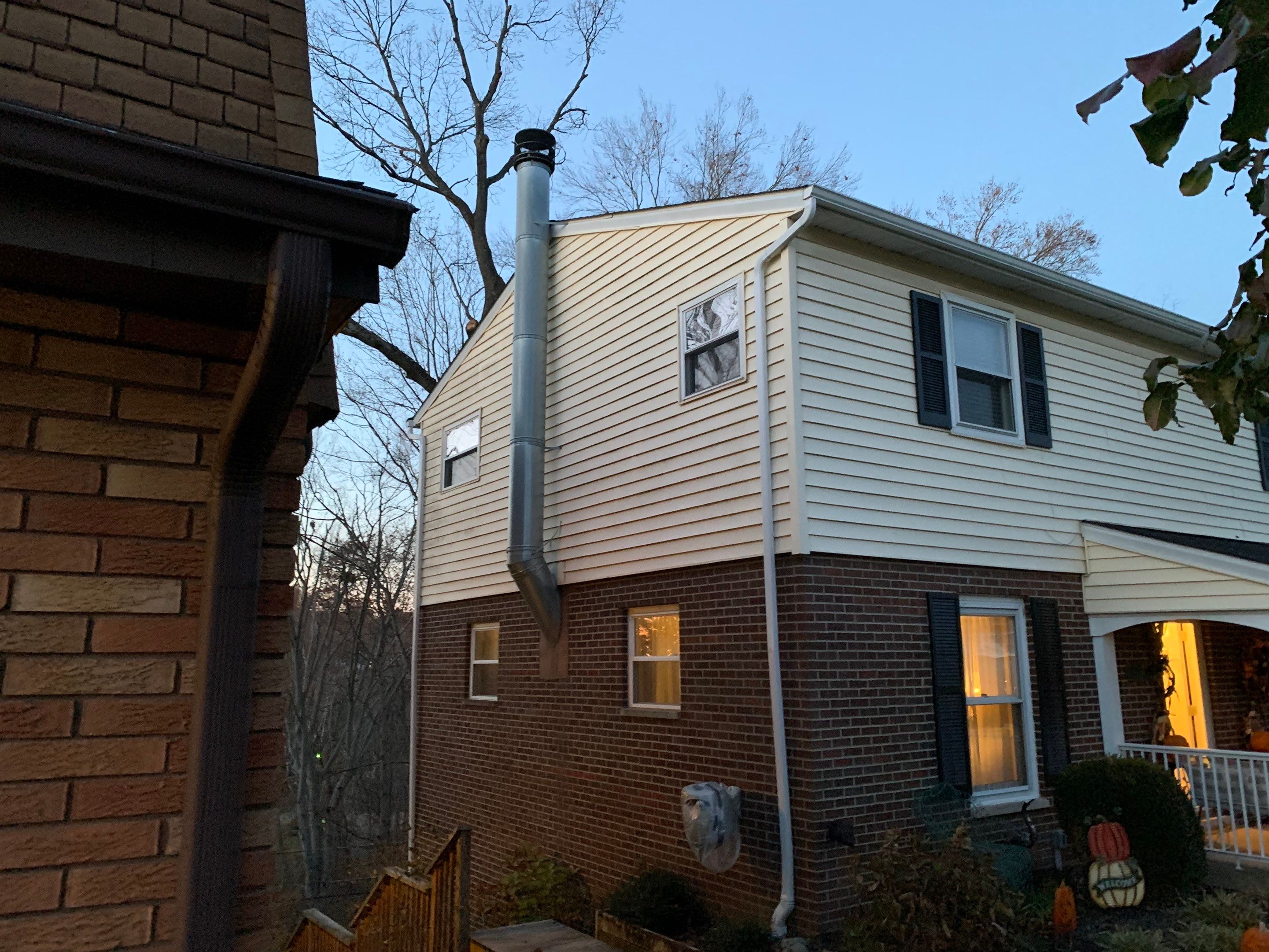 Replace dated vinyl siding with new white exterior Portfolio vinyl siding  by Secure Construction Company Inc