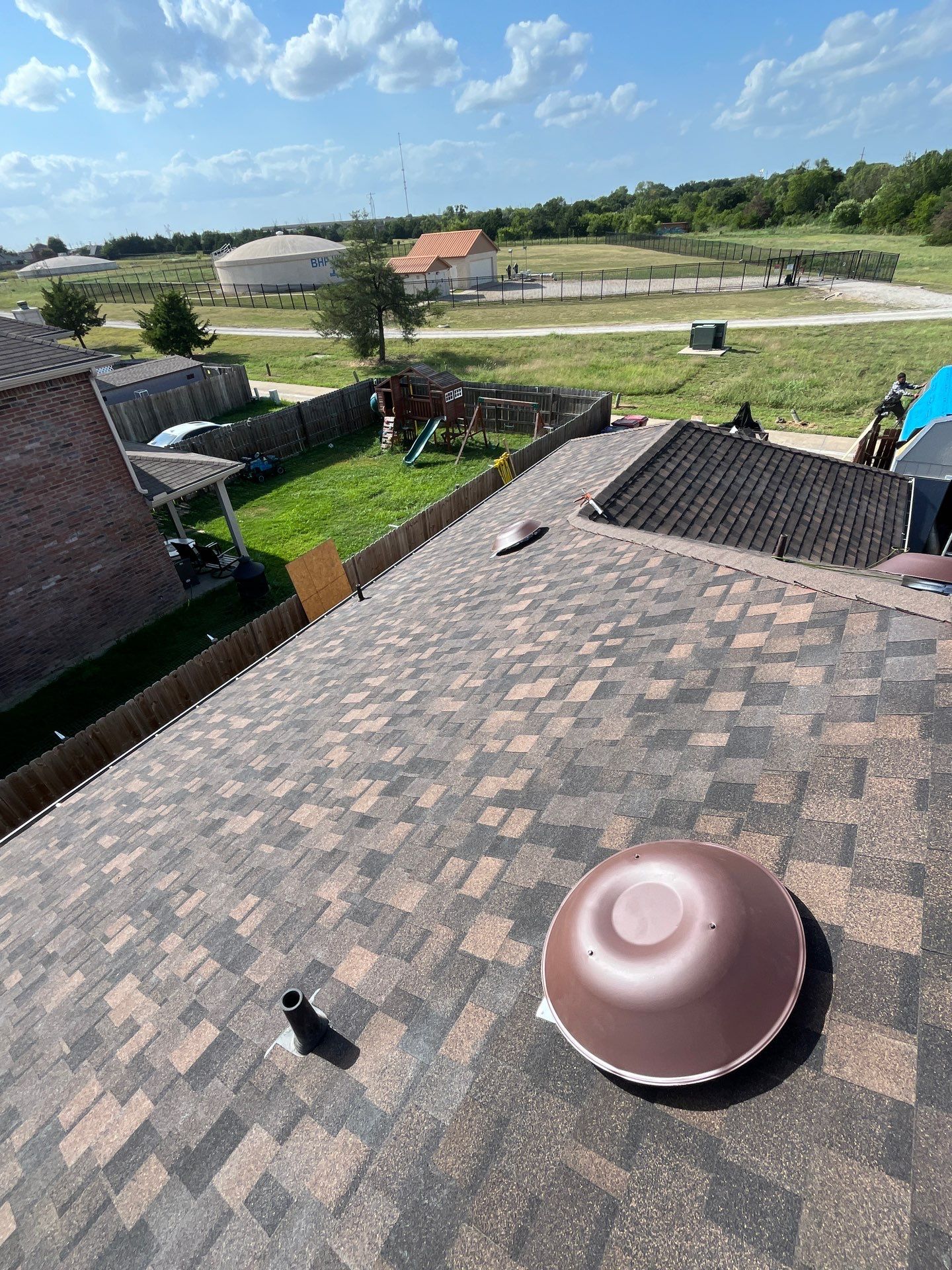 IKO Shadow Brown-Medium brown brick house by Tejas Roofworks + Restoration