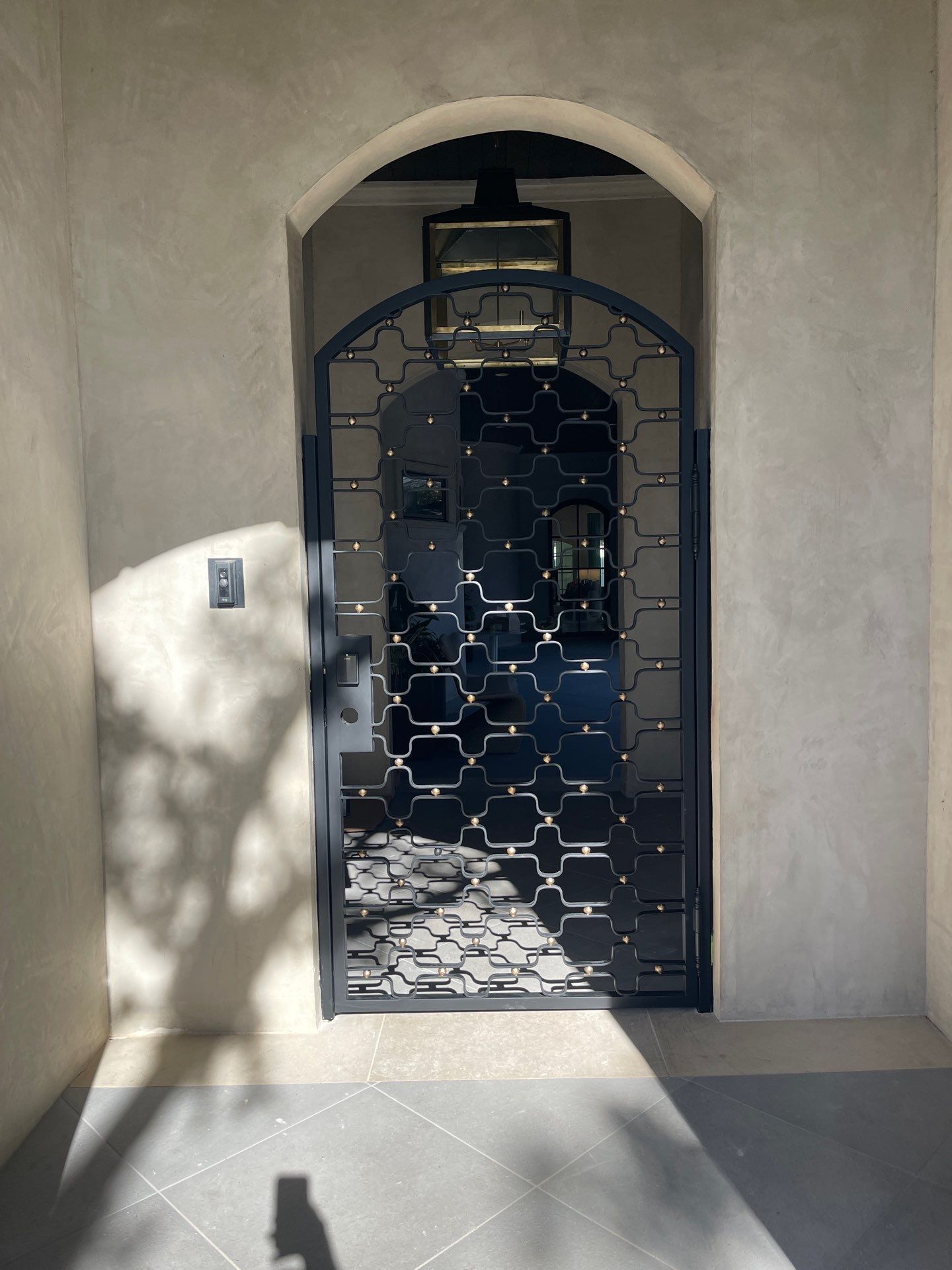 Arched Decorative Metal Security Gate Installation in Dallas by Solara Custom Living
