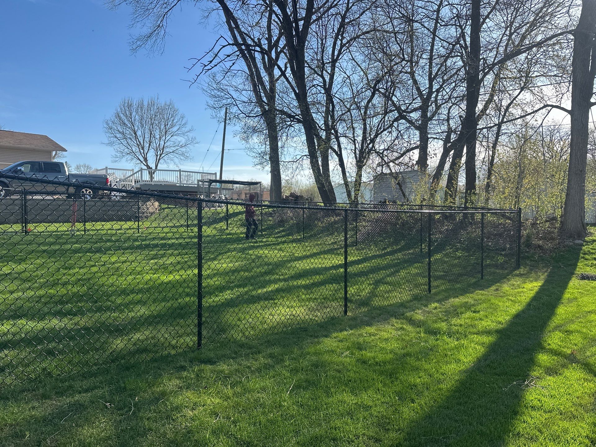 Black Vinyl-Coated Chain Link Fence Installation in Waterloo by Perfect Picket Fence and Stain