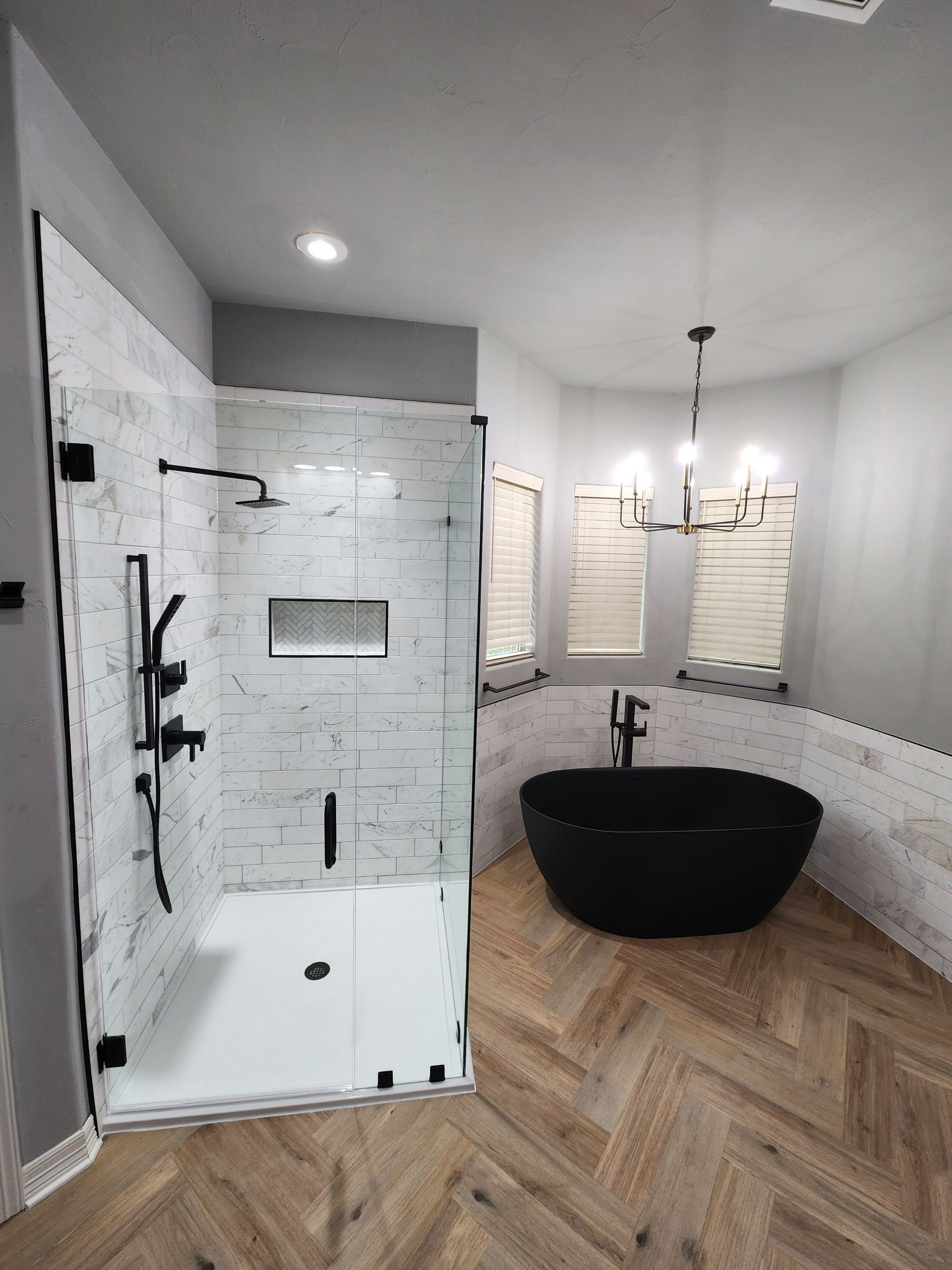 Spring Bathroom Remodel with Black Free-Standing Tub and Walk-In Shower by Legacy Bath and Kitchen