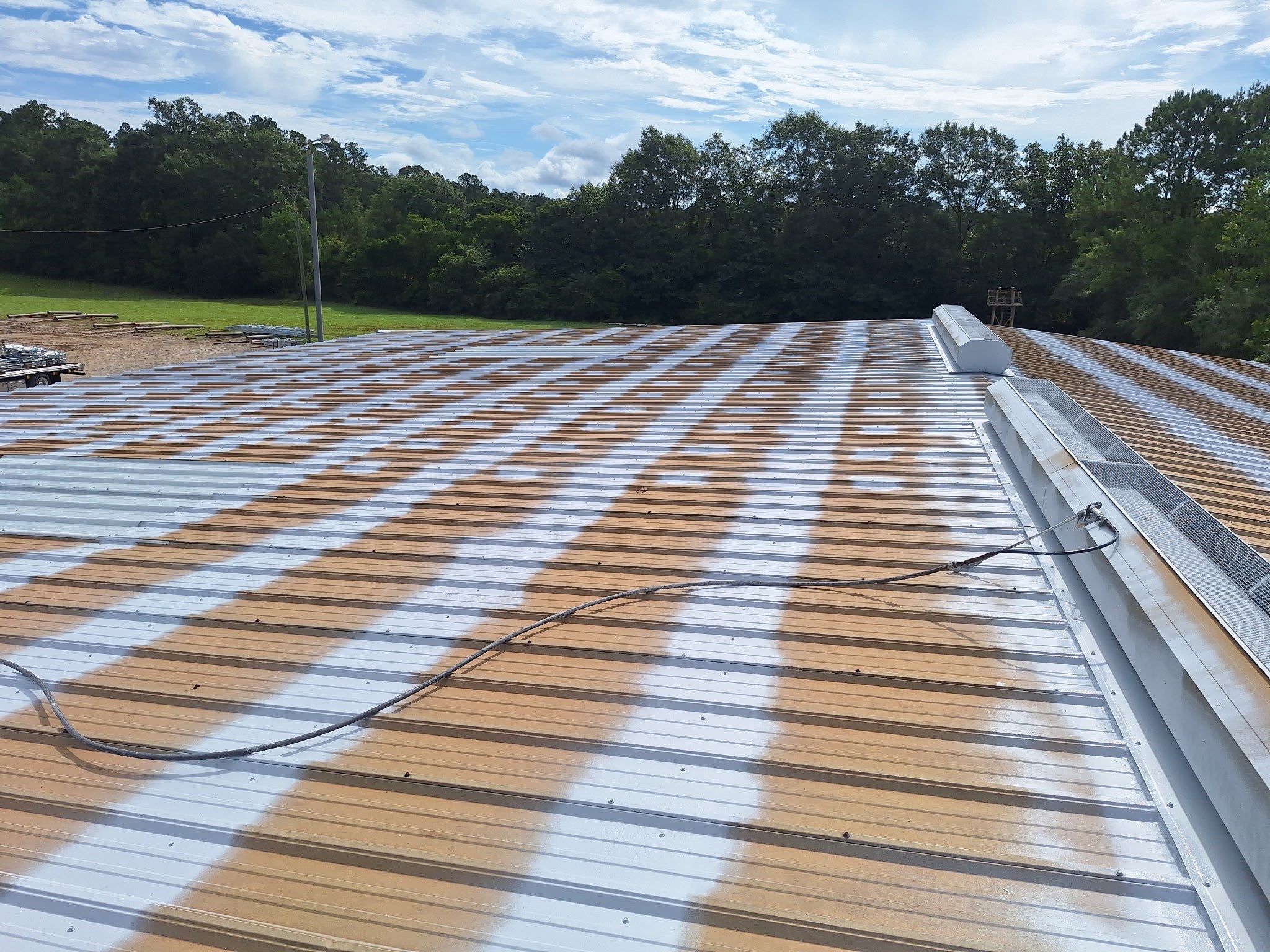 Commercial Metal Roof Restoration with White Protective Coating by Southern Roof Solutions