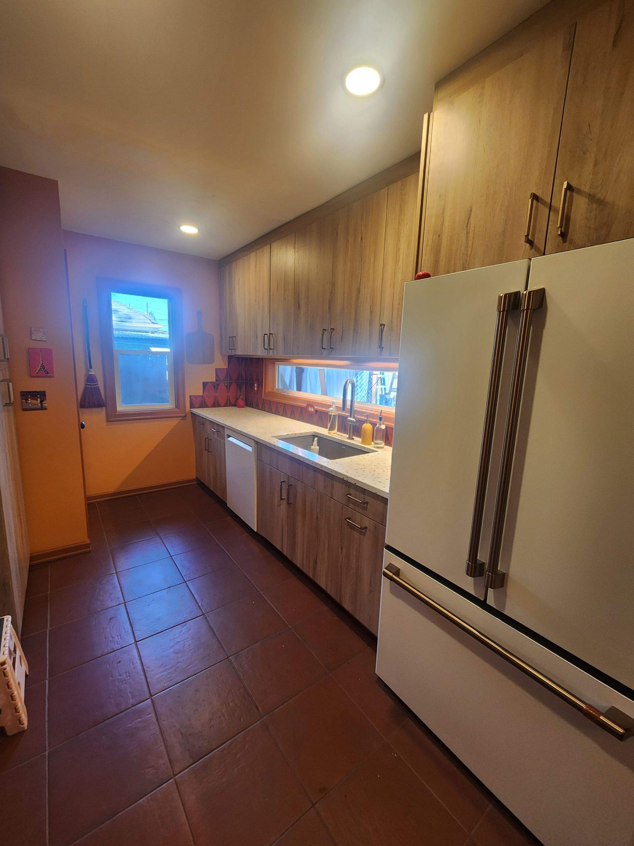 Complete Kitchen Remodeling Featuring Terracotta Tile and Wood Cabinetry by American Made Construction 