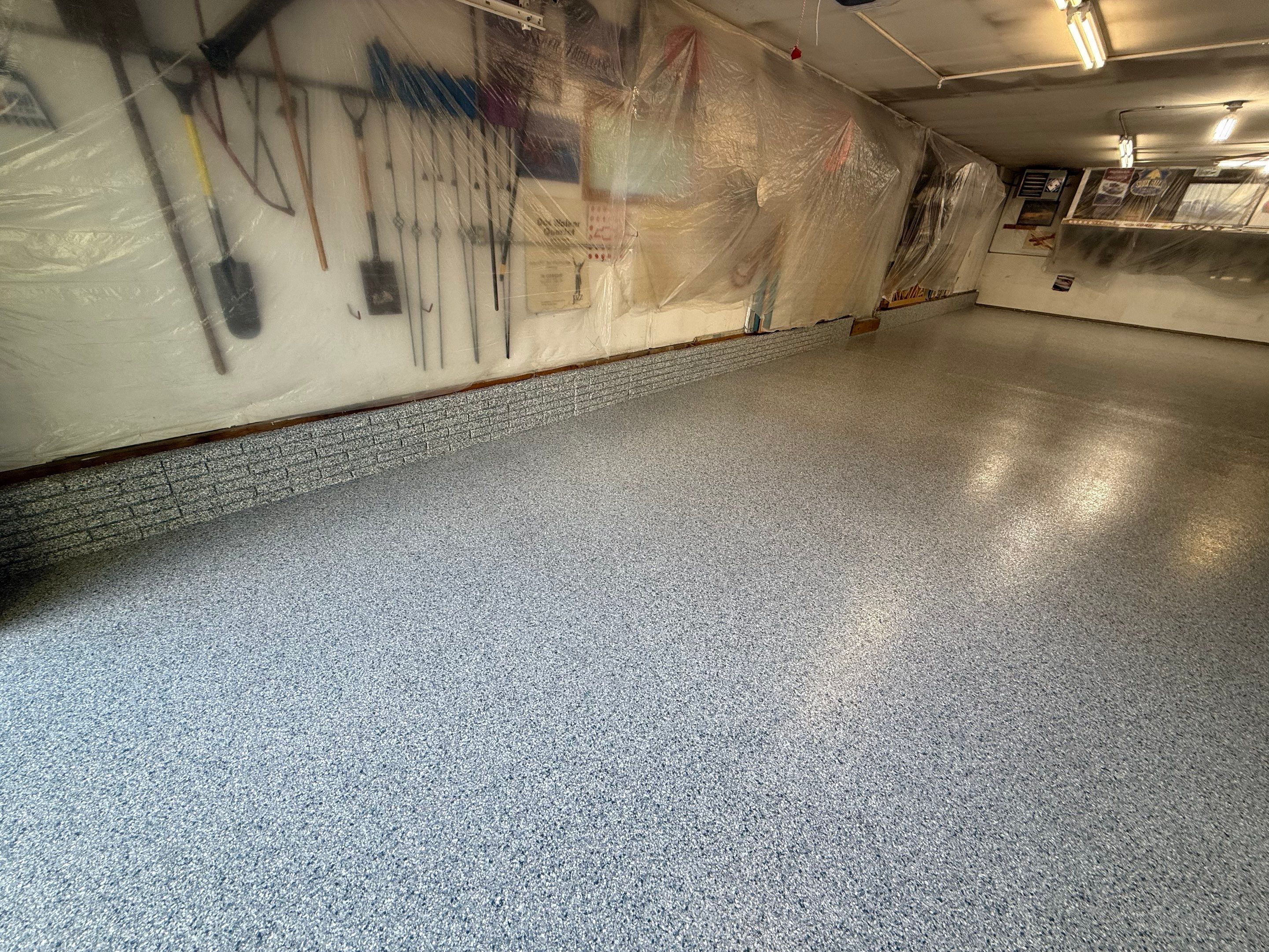 High-Performance Polyurea Garage Floor Coating and Stem Wall Finishing in Sioux Falls by Select Painting, Coatings & Garage Cabinets