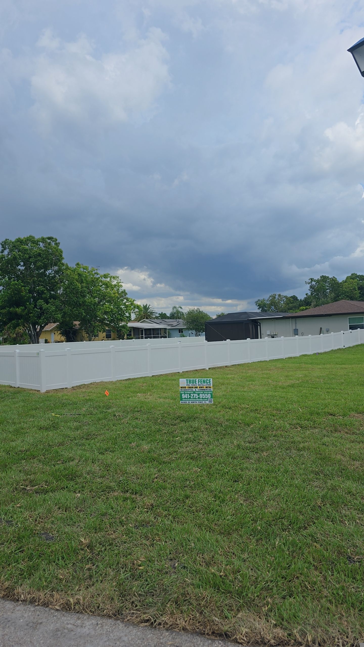 White Vinyl Privacy Fence Installation on Port Charlotte Corner Lot by True Fence LLC