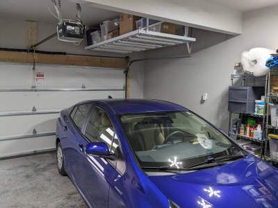 John H. maximized his storage with overhead racks and wall shelves