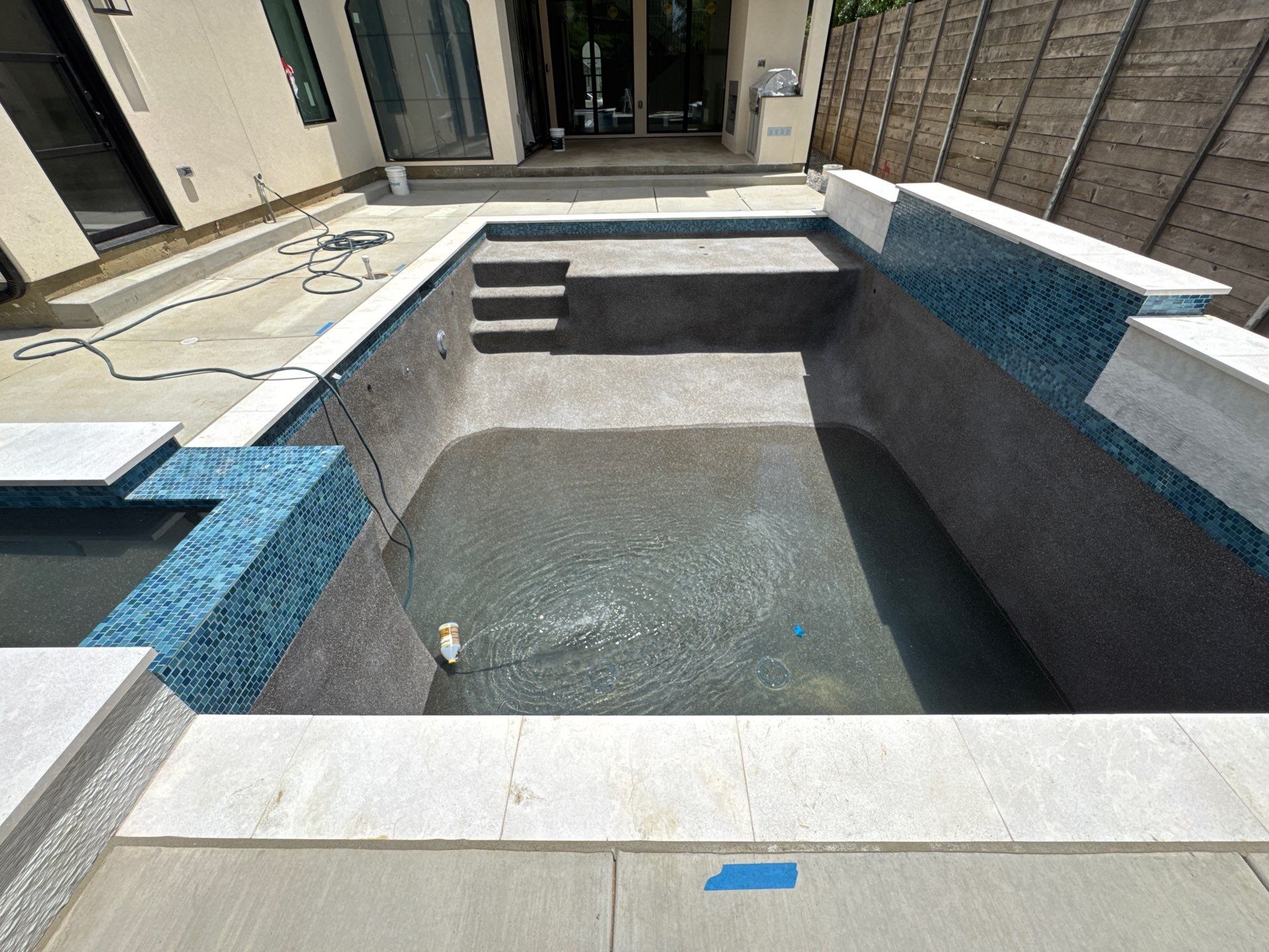 Modern Pool with Raised Glass-Tile Spa by Pinnacle Pools and Spas - DFW