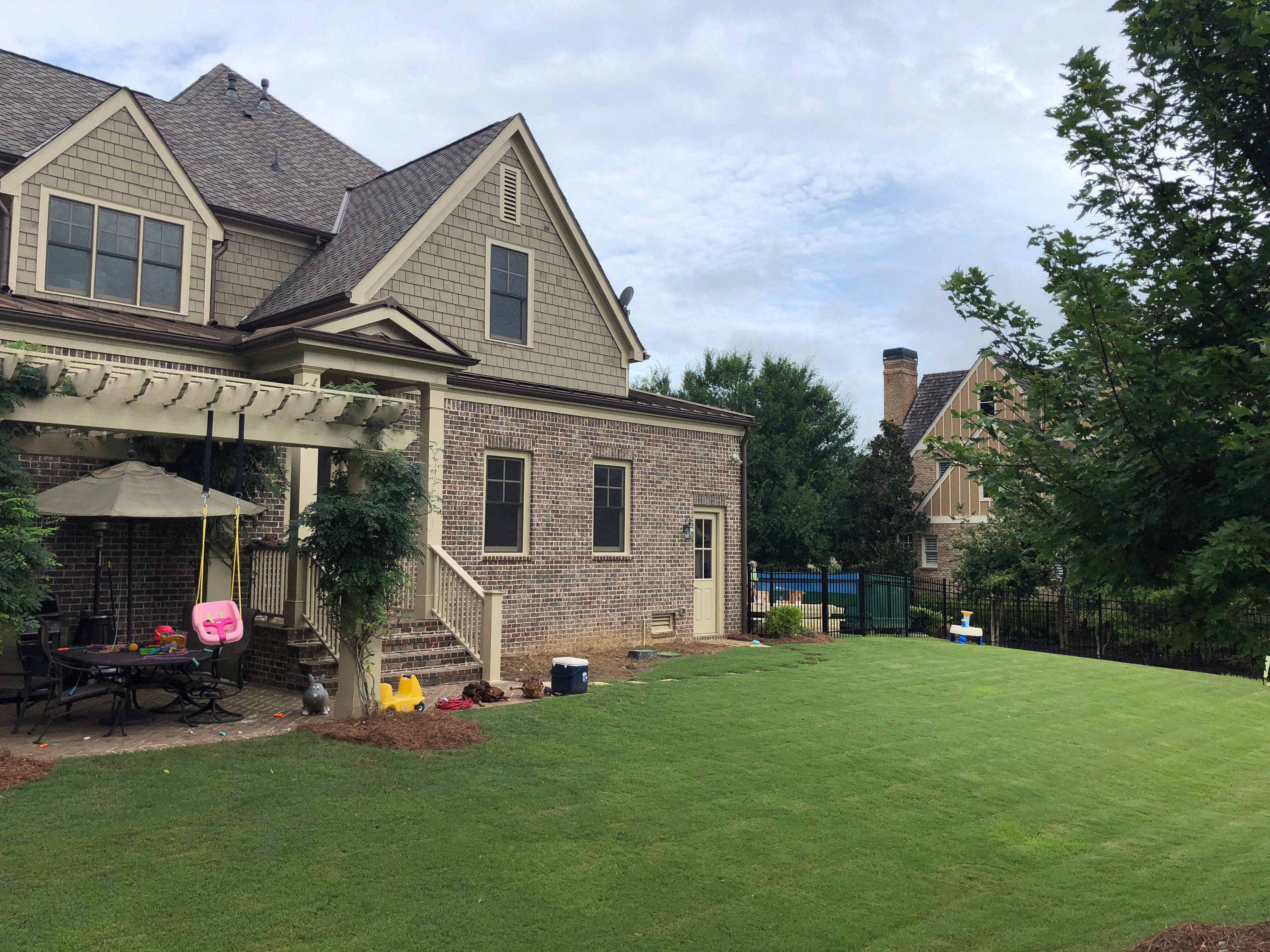 Custom Screened Porch Addition with White Brick Fireplace in Duluth by Swift Home Renovations