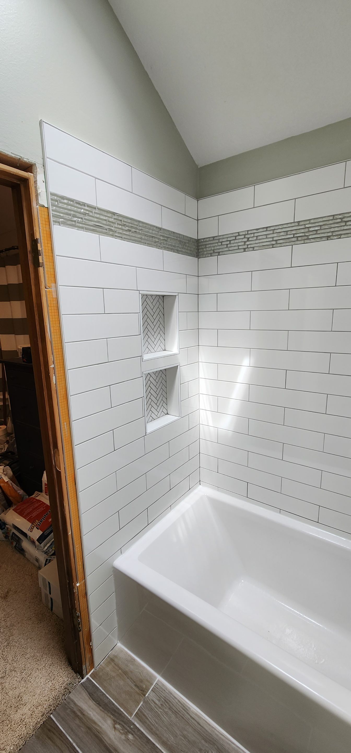 Beautiful tile tub surround and tile floors! Customer started, TSC finished by The Shower Company