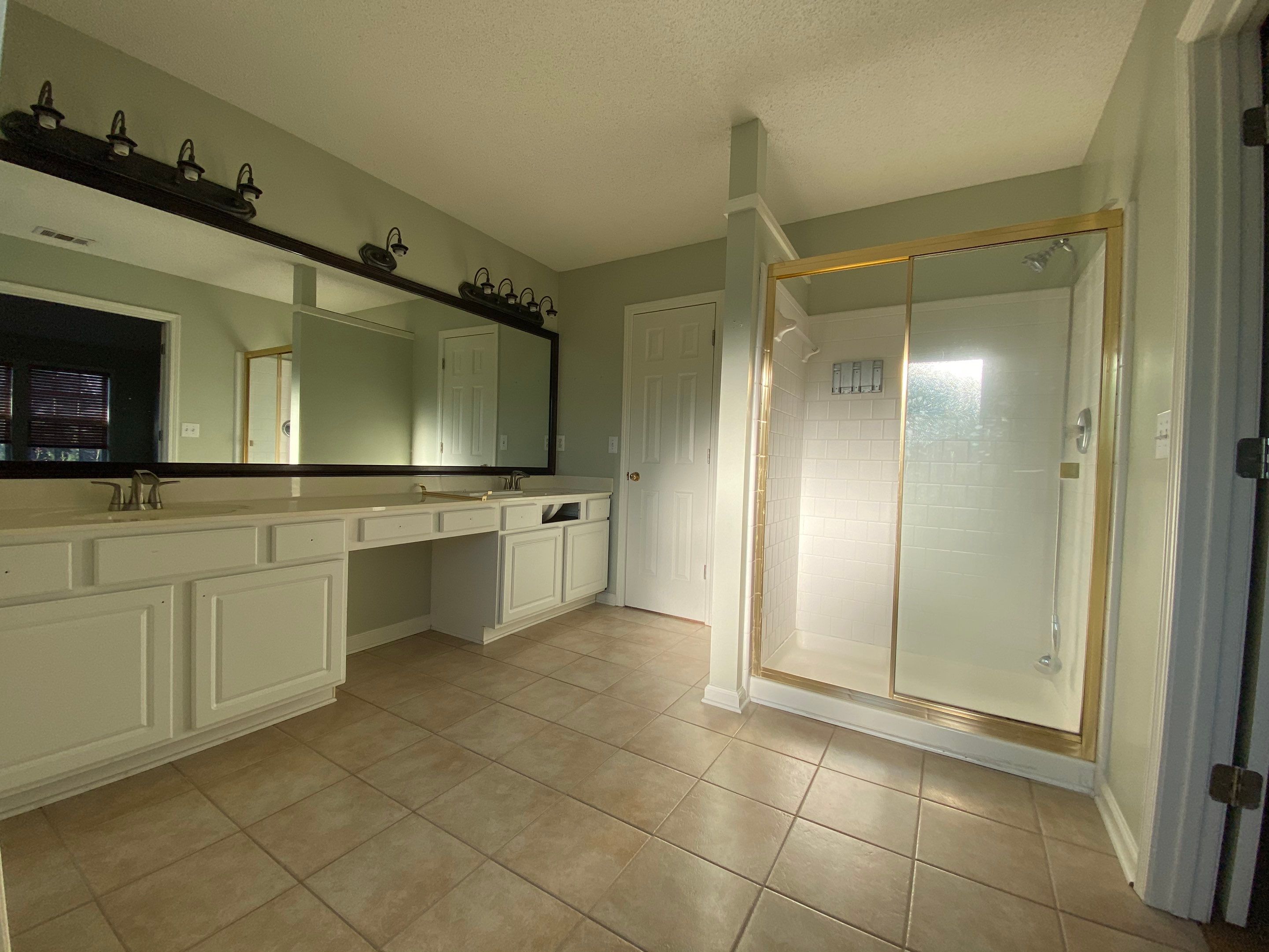 Master Bathroom Renovation Featuring Marble-Look Tile and Frameless Glass by Swift Home Renovations
