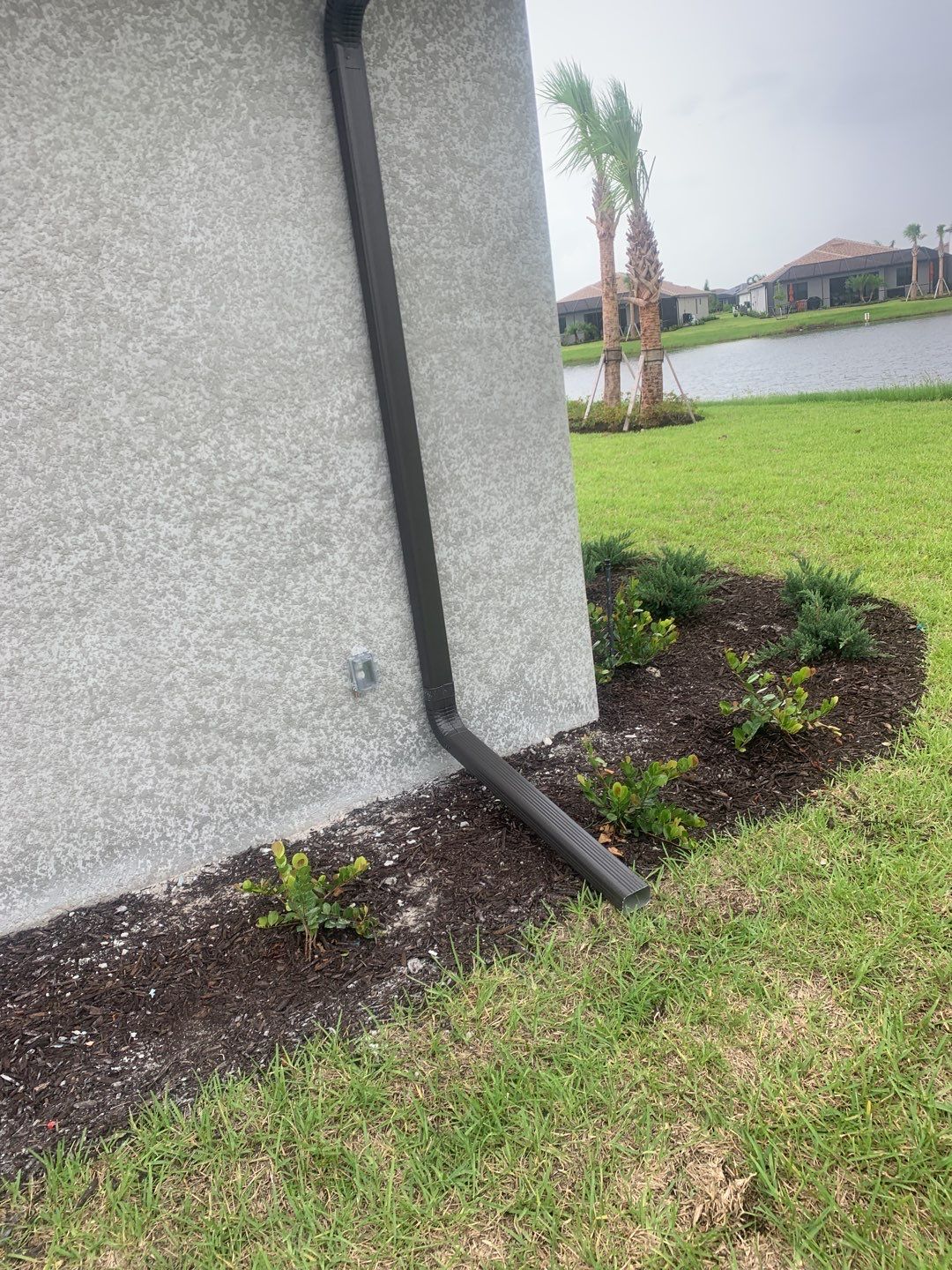 Seamless brown gutter and downspouts installation in Estero, FL  by Gutter Professors