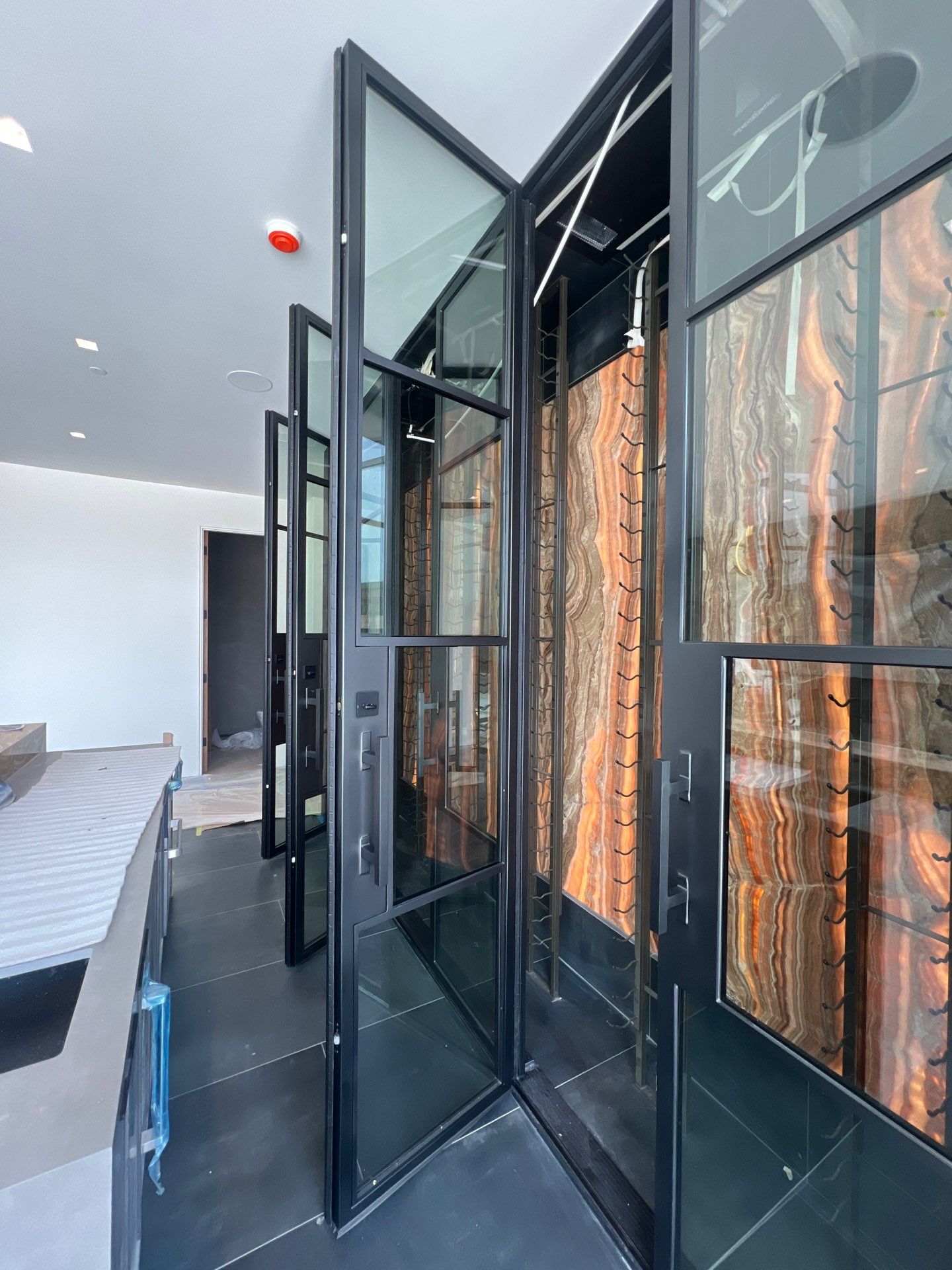 Custom Black-Framed Glass Wine Cellar Installation in Dallas by Solara Custom Living