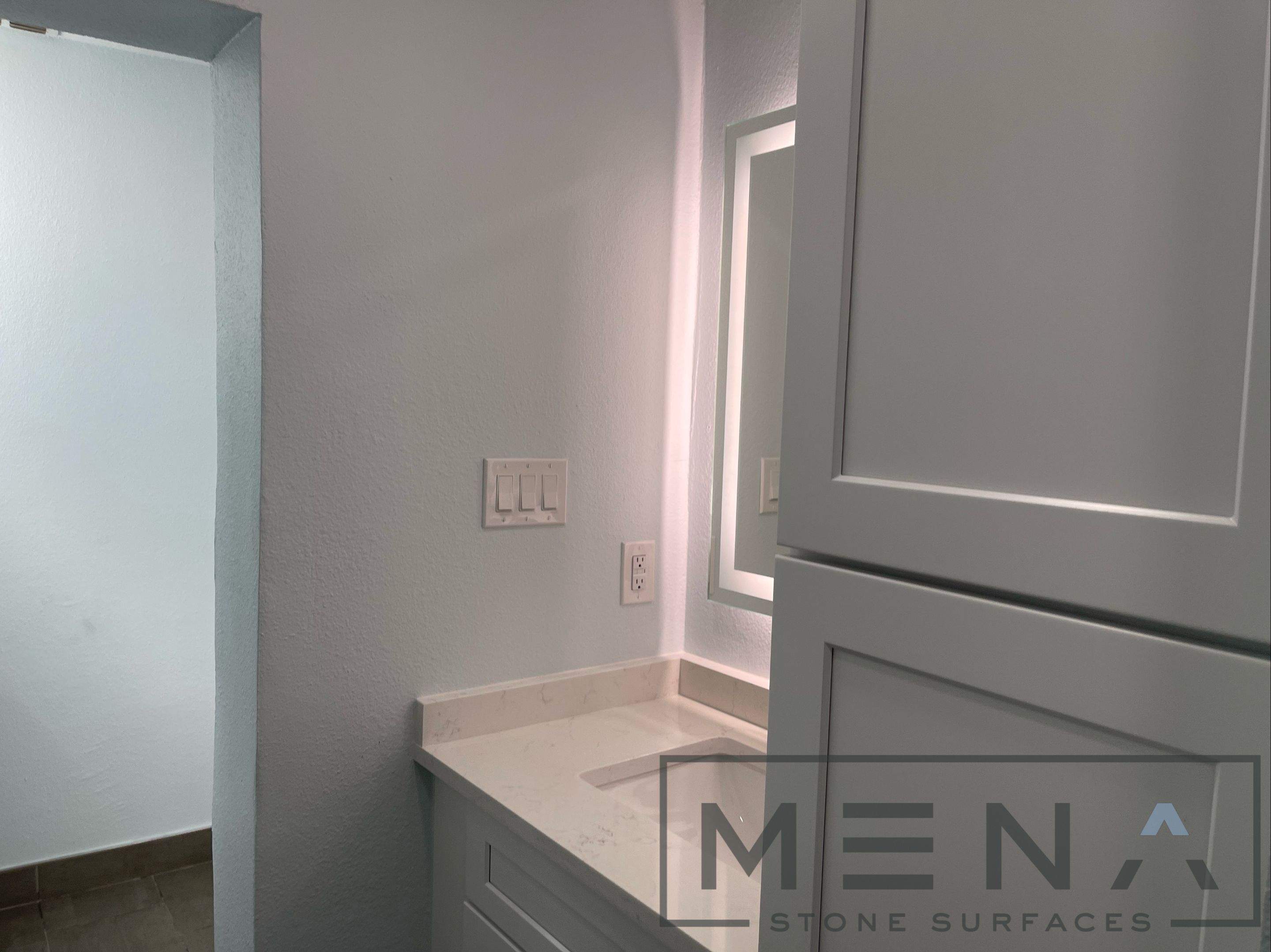 Complete Bathroom Remodel Featuring Marble Tile and Teal Herringbone Niche by Mena stone surfaces